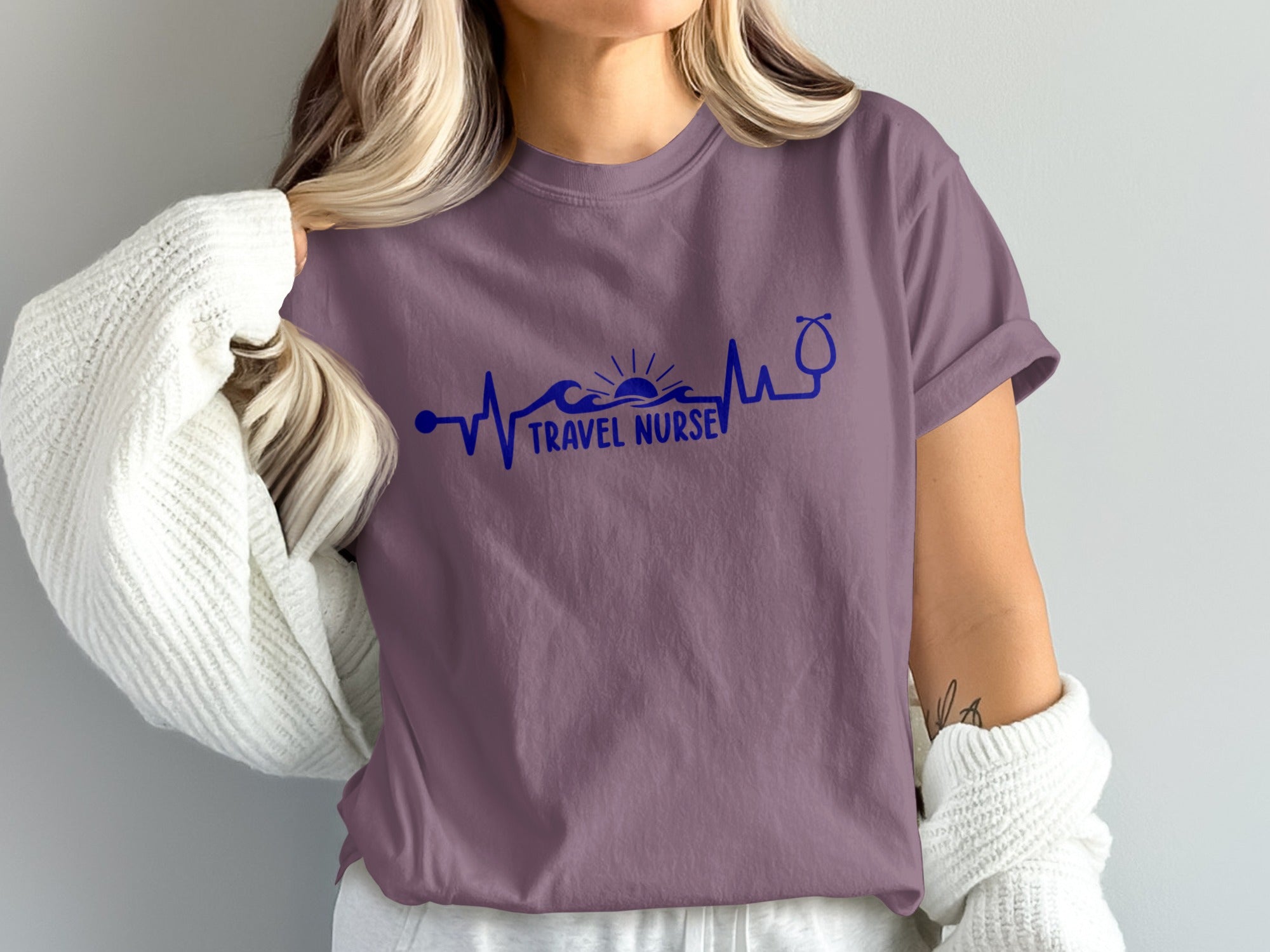 Purple t-shirt with "Travel Nurse" text, heartbeat wave, and stethoscope graphic.
