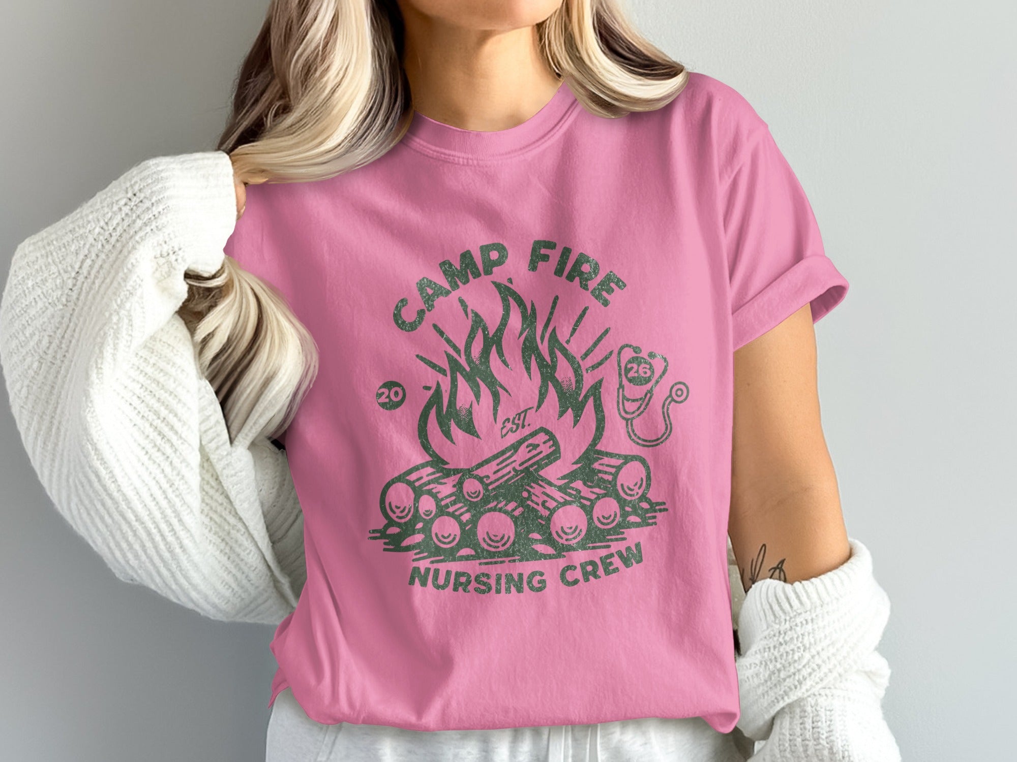 Pink t-shirt with campfire graphic and "Nursing Crew" text.