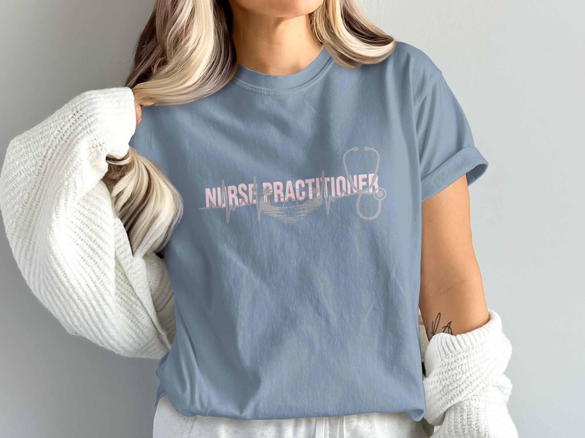 Blue t-shirt with stethoscope and "Nurse Practitioner" heartbeat graphic.