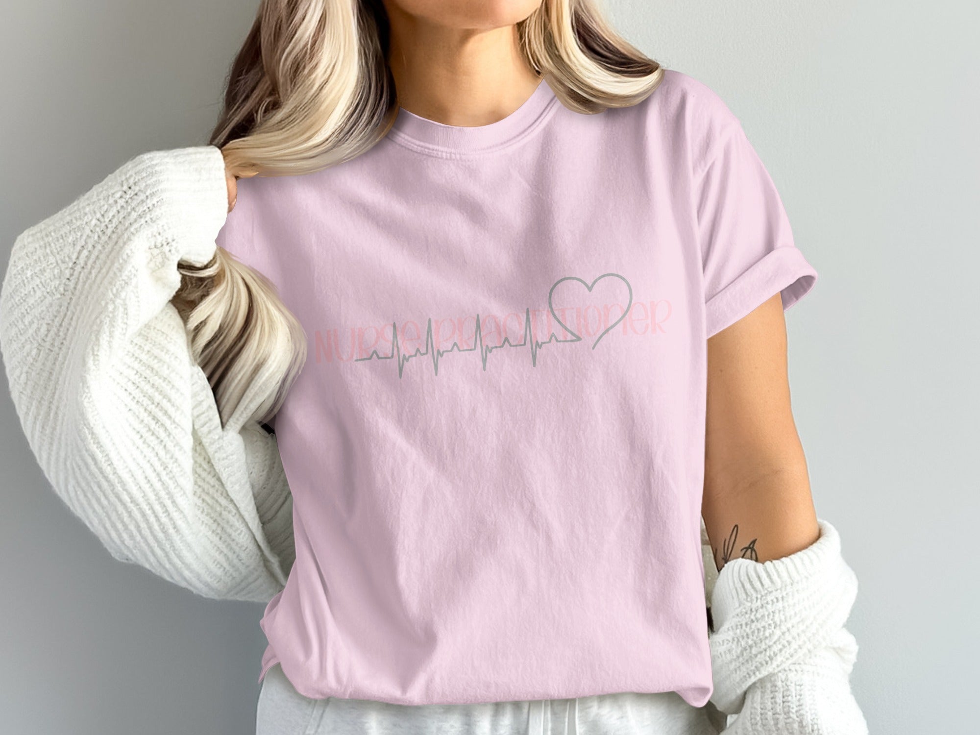 Pink t-shirt with "Nurse Life" and a heart pulse graphic.