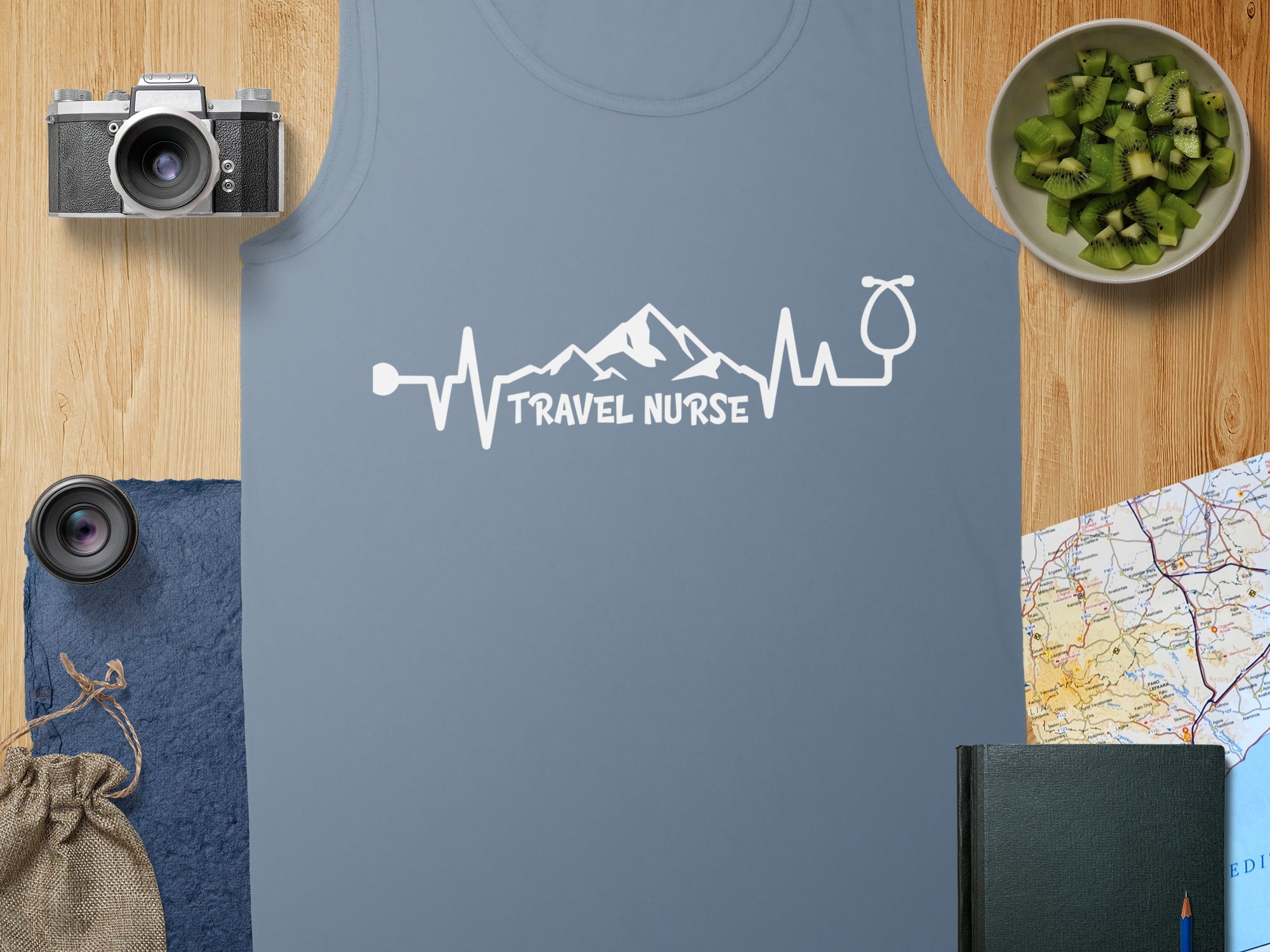Blue tank top with "Travel Nurse" text featuring a mountain and heartbeat design.