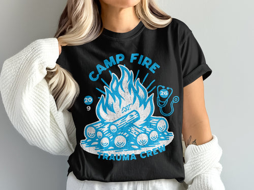 Black t-shirt with a blue campfire graphic and "Camp Fire Trauma Crew" text.
