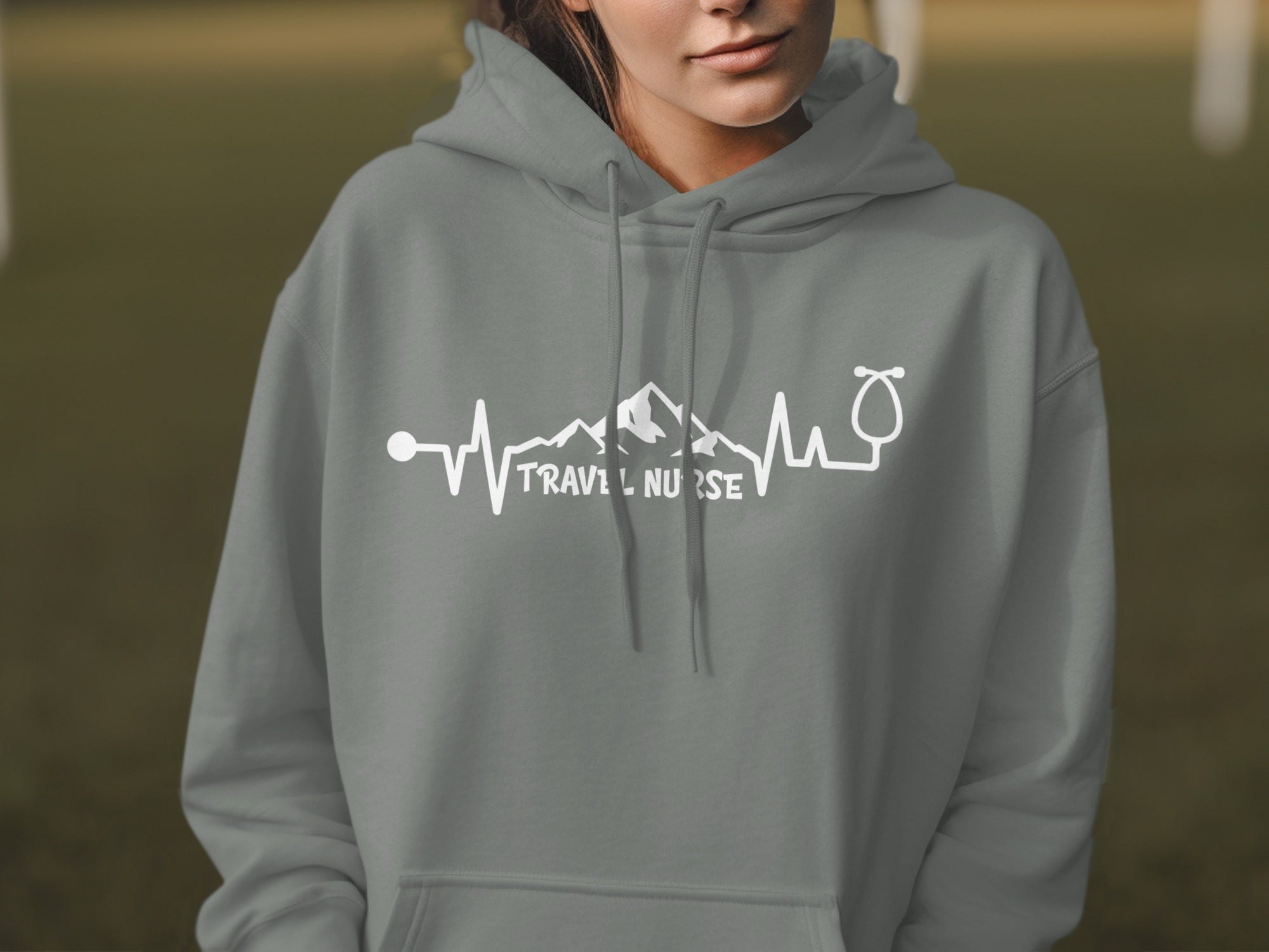 Grey hoodie with "Travel Nurse" text and mountain heartbeat graphic.