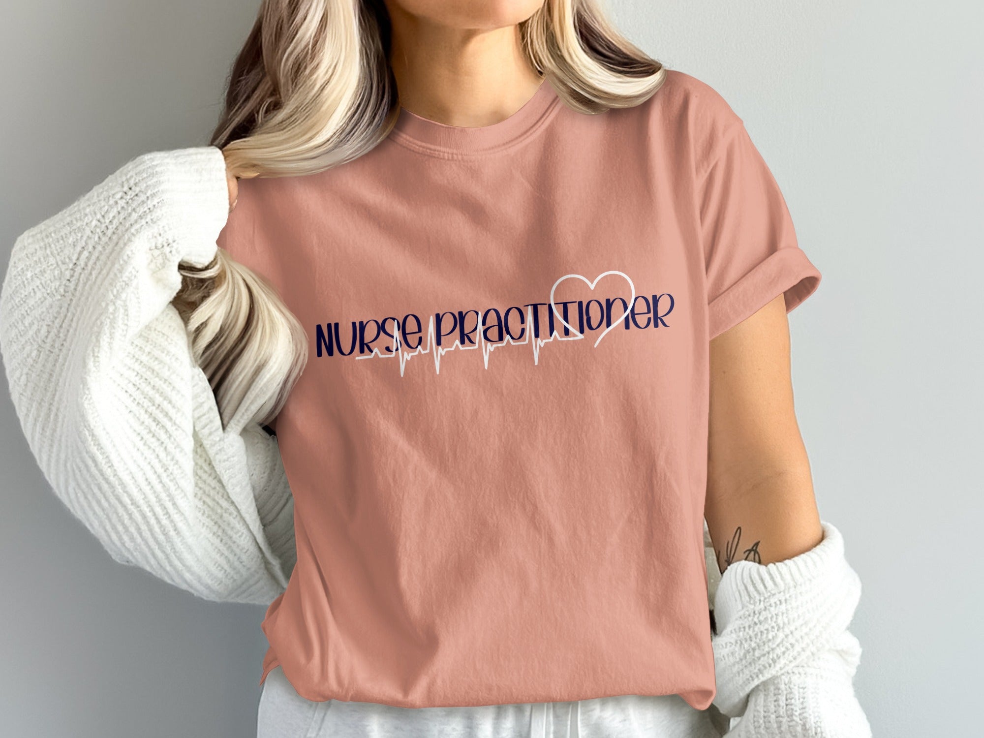Coral t-shirt with "Nurse Practitioner" and a heartbeat graphic.