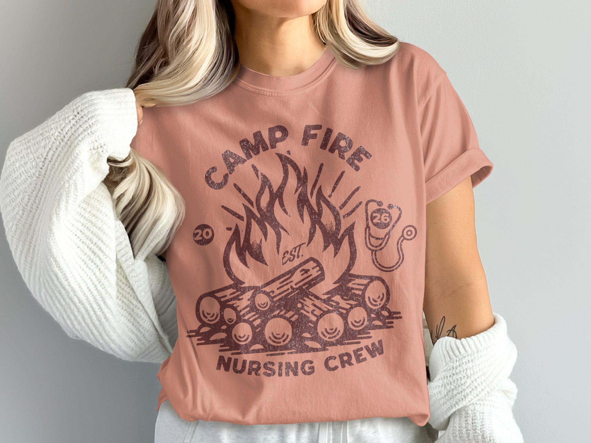 Camp Fire Nursing Crew graphic tee with flames, logs, and stethoscope.