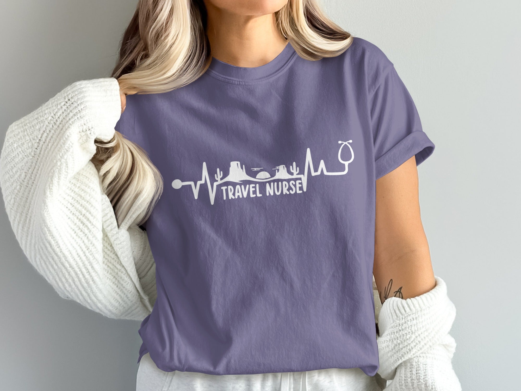 Purple t-shirt with a heartbeat line graphic and "TRAVEL NURSE" text.