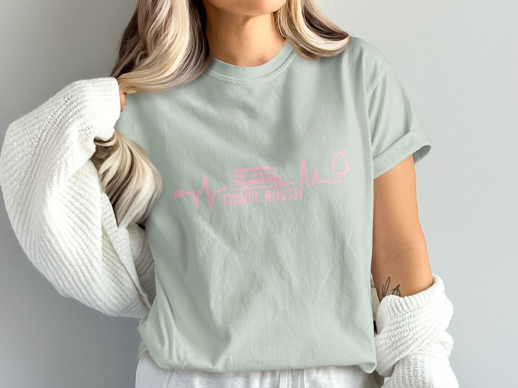 Pale green t-shirt with pink travel nurse graphic.