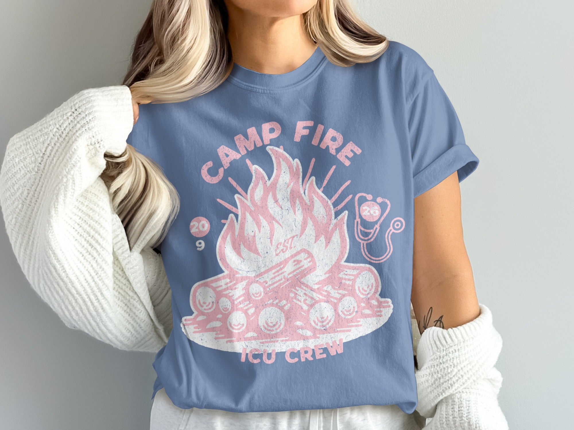 Blue t-shirt with pink campfire graphic and "Camp Fire ICU Crew" text.