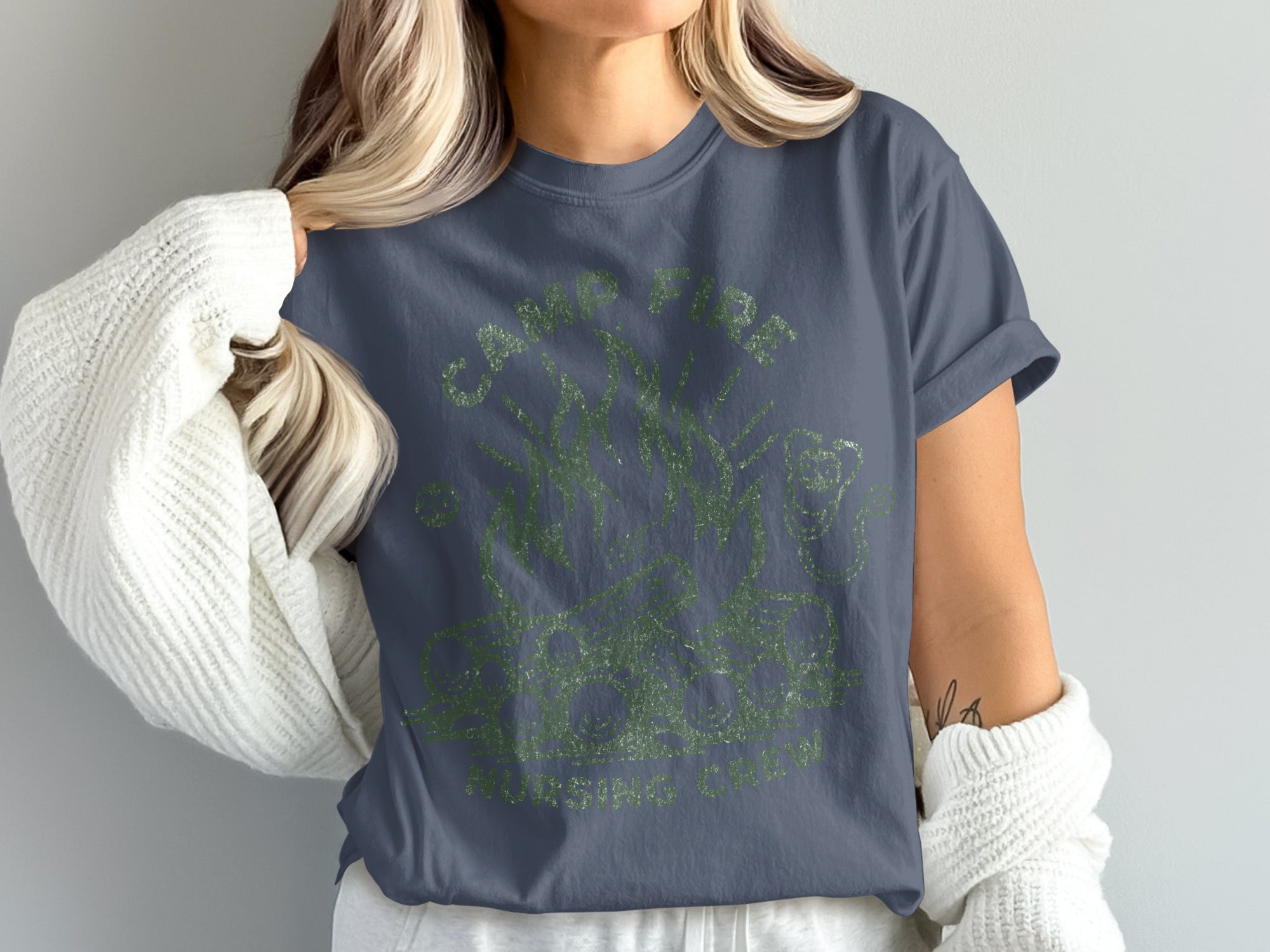 Navy t-shirt with distressed green graphic text and illustration of plants.