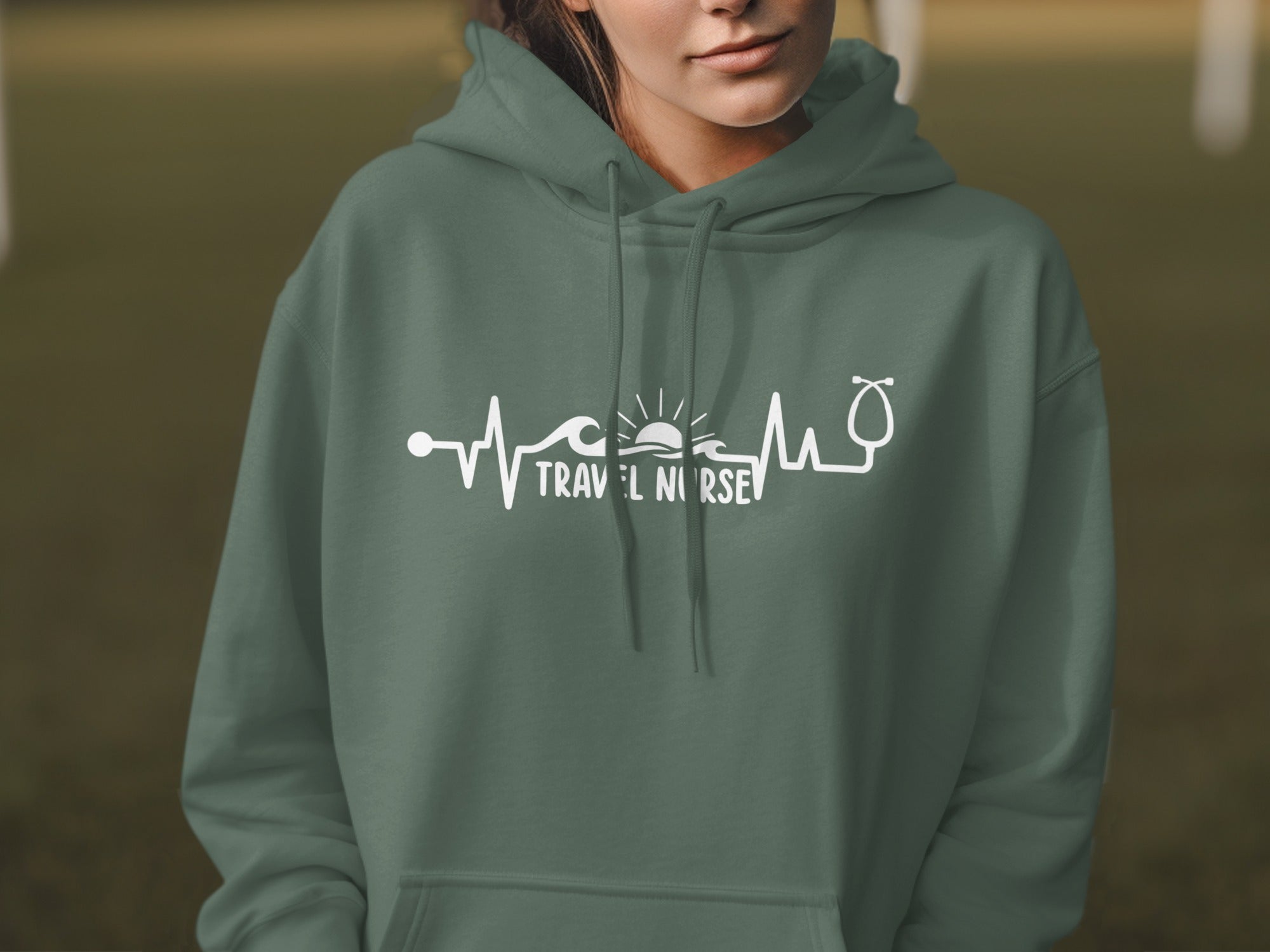 Green hoodie with "Travel Nurse" text and heartbeat, wave, and sun graphic.