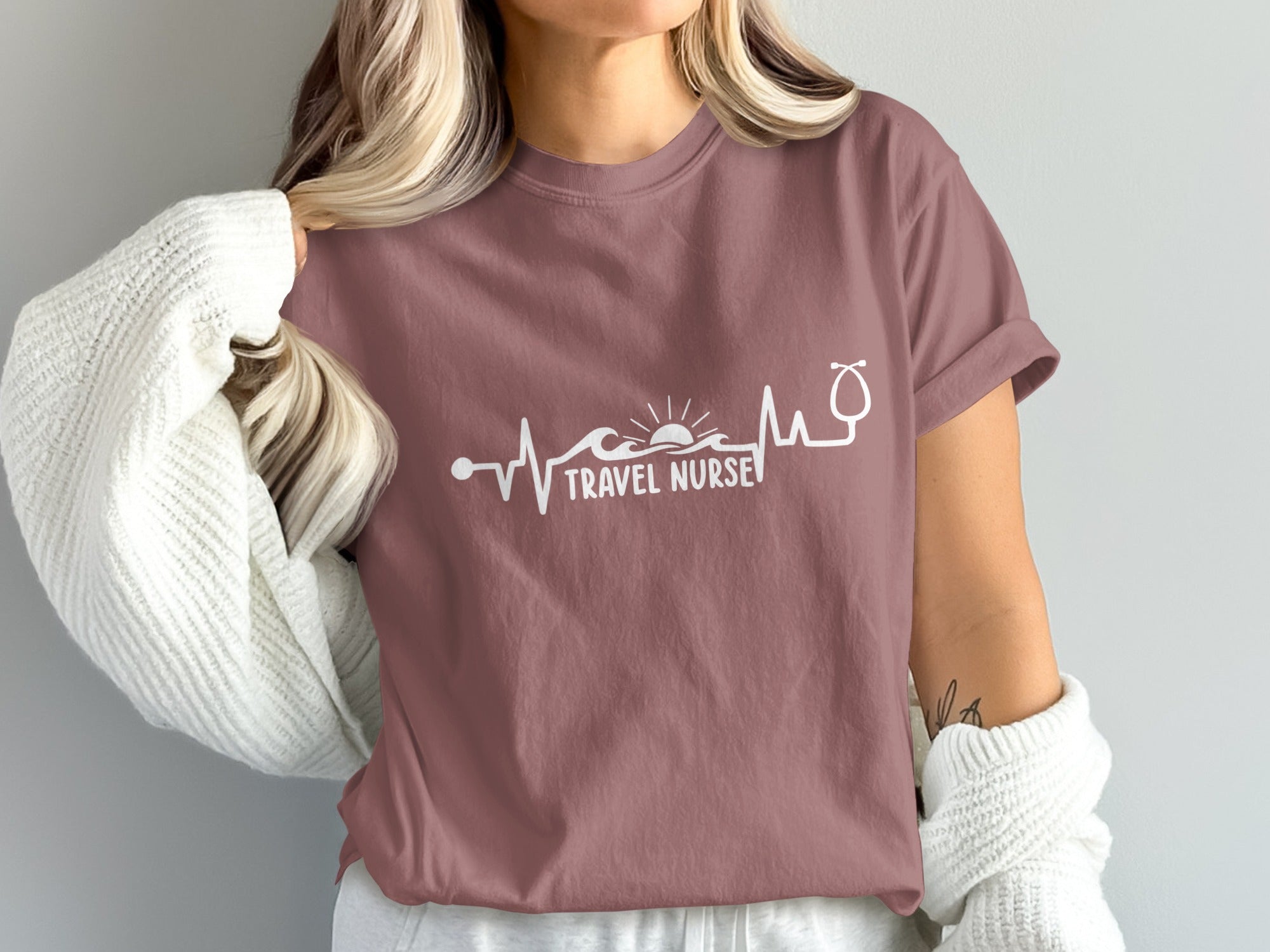 Mauve t-shirt with "TRAVEL NURSE" text and a stethoscope heart rhythm design.