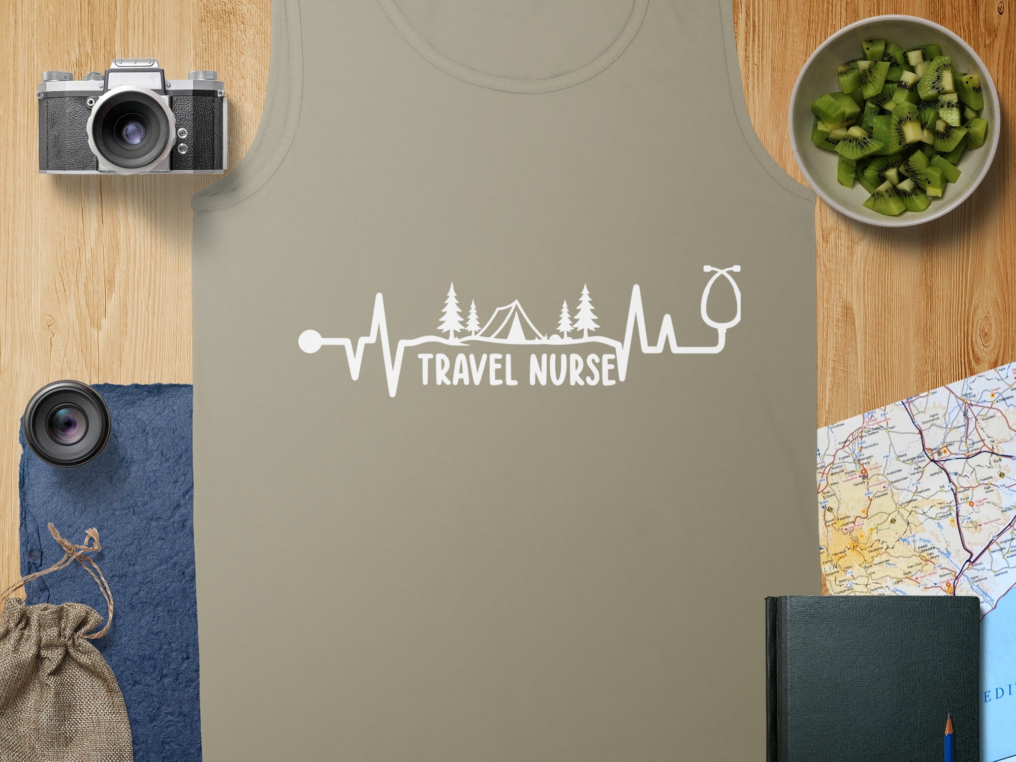 Tank top with "Travel Nurse" text, heartbeat, and mountain tent graphic.