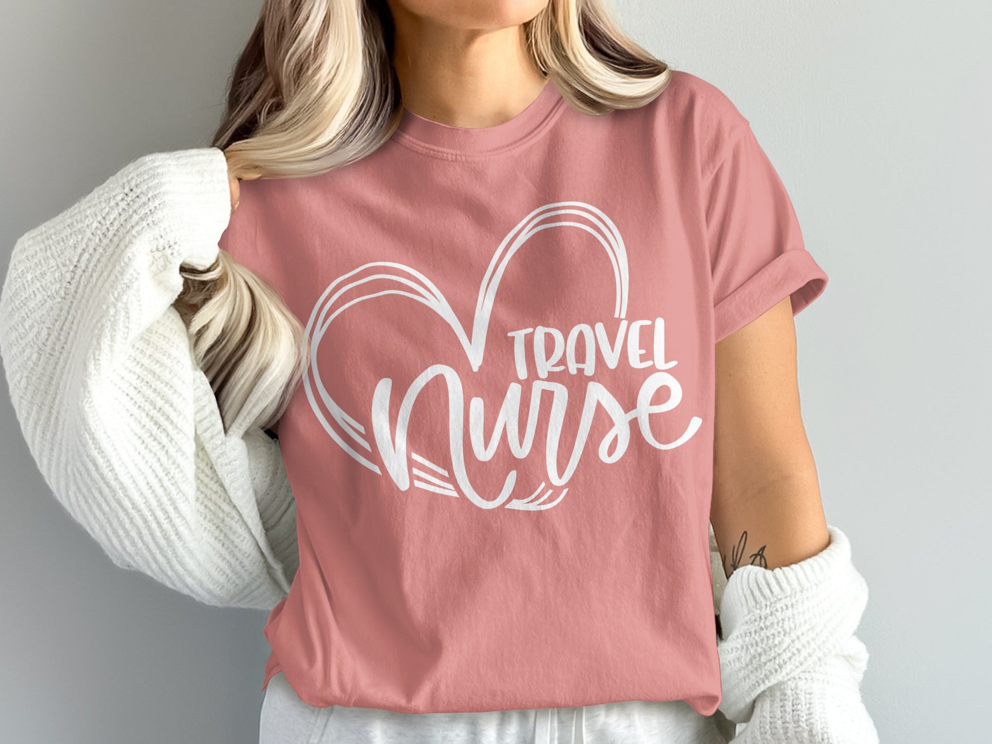 Pink t-shirt with "Travel Nurse" written inside a heart outline.