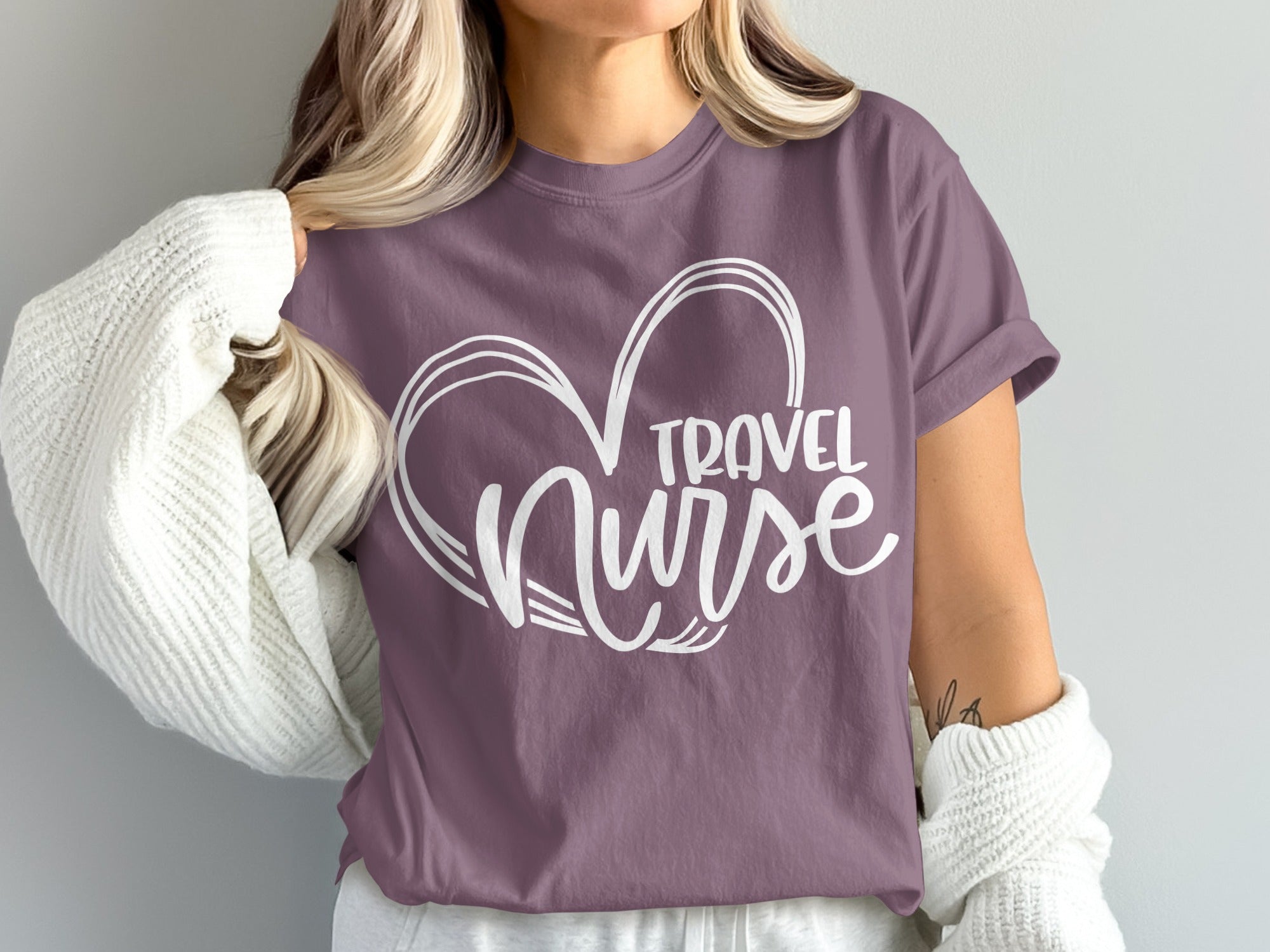 Purple t-shirt with white "Travel Nurse" heart graphic.