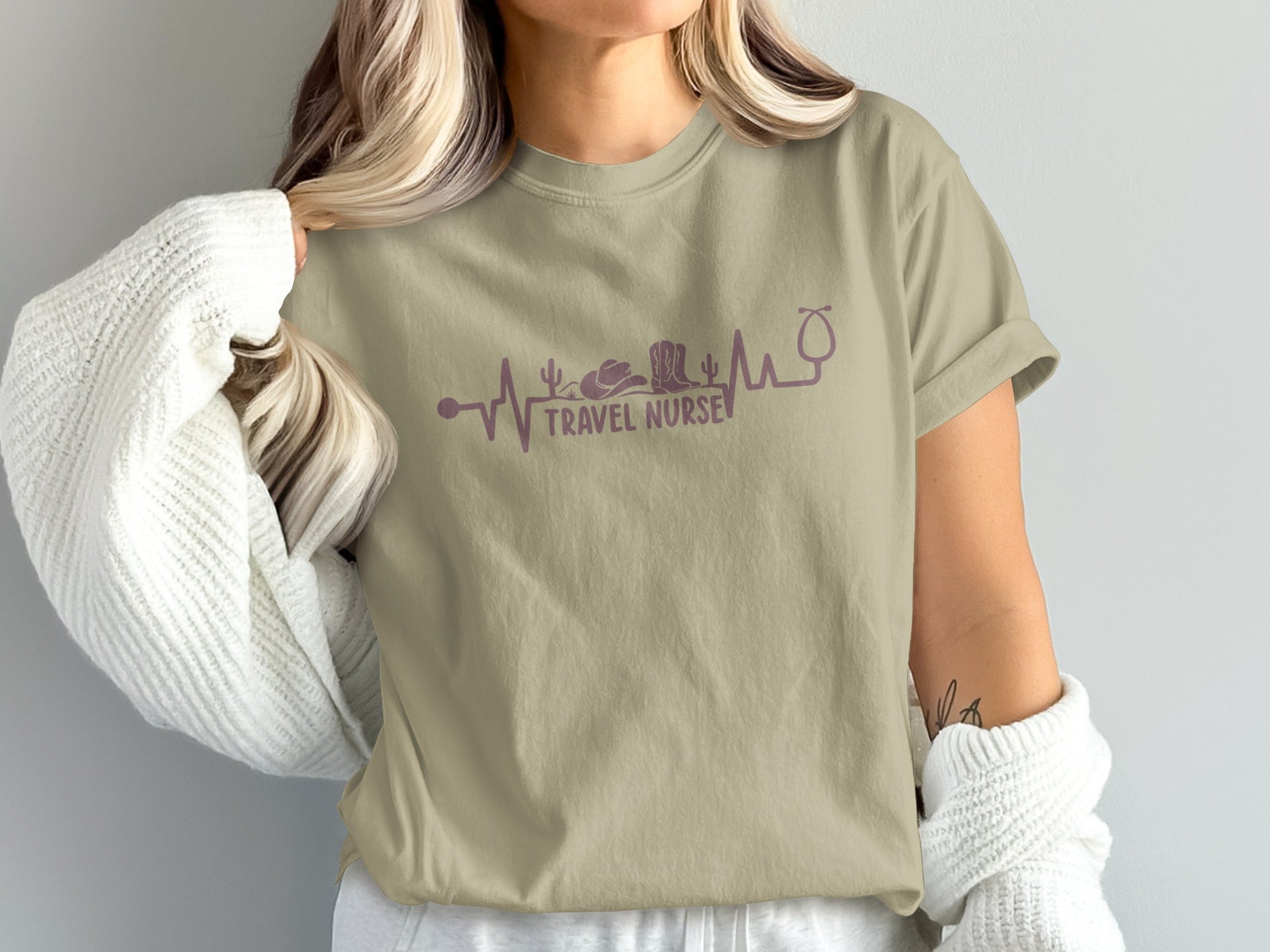 Tan t-shirt with "Travel Nurse" text and stethoscope, cactus, and cowboy hat graphic.