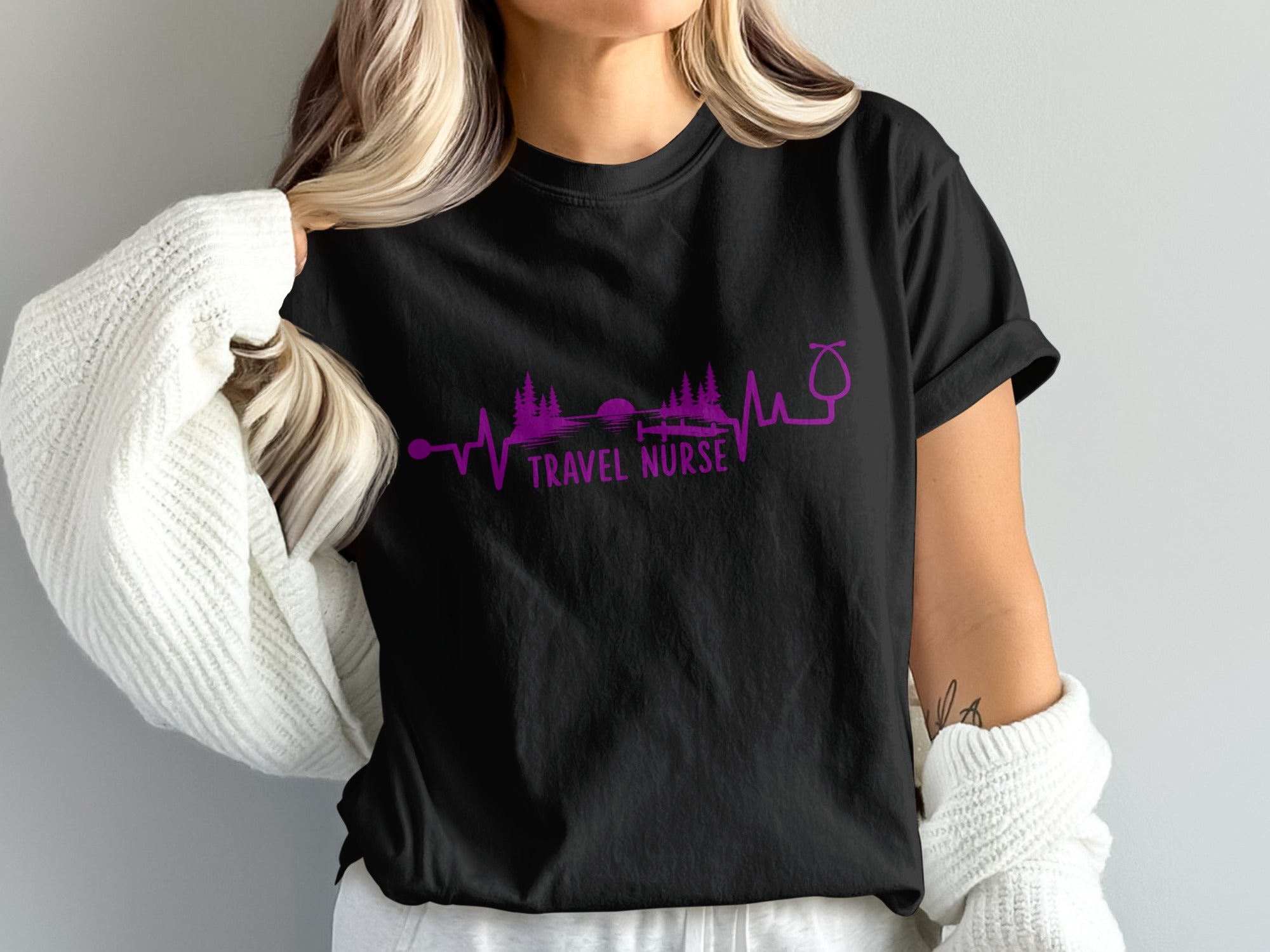 Black t-shirt with purple stethoscope and "Travel Nurse" text on landscape heartbeat line.
