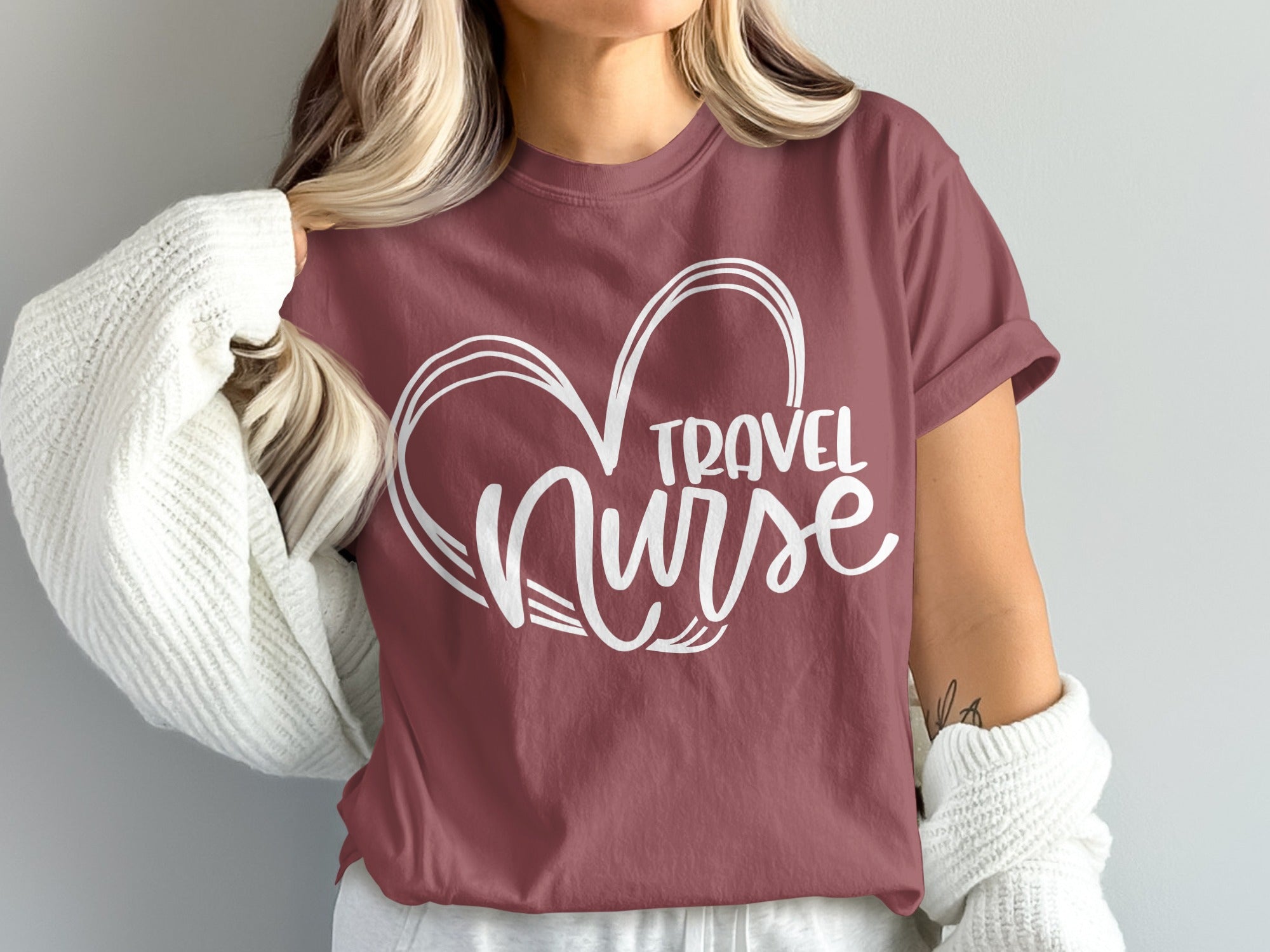 Maroon t-shirt with white heart and "Travel Nurse" text.