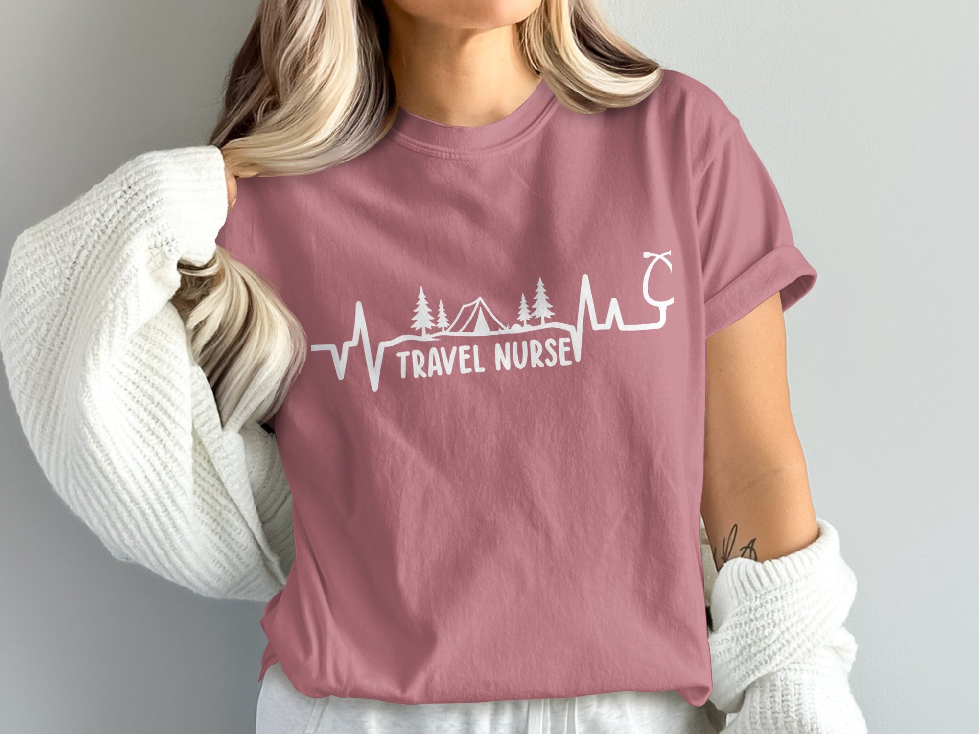Mauve t-shirt with "Travel Nurse" text and stethoscope, mountains, and trees design.