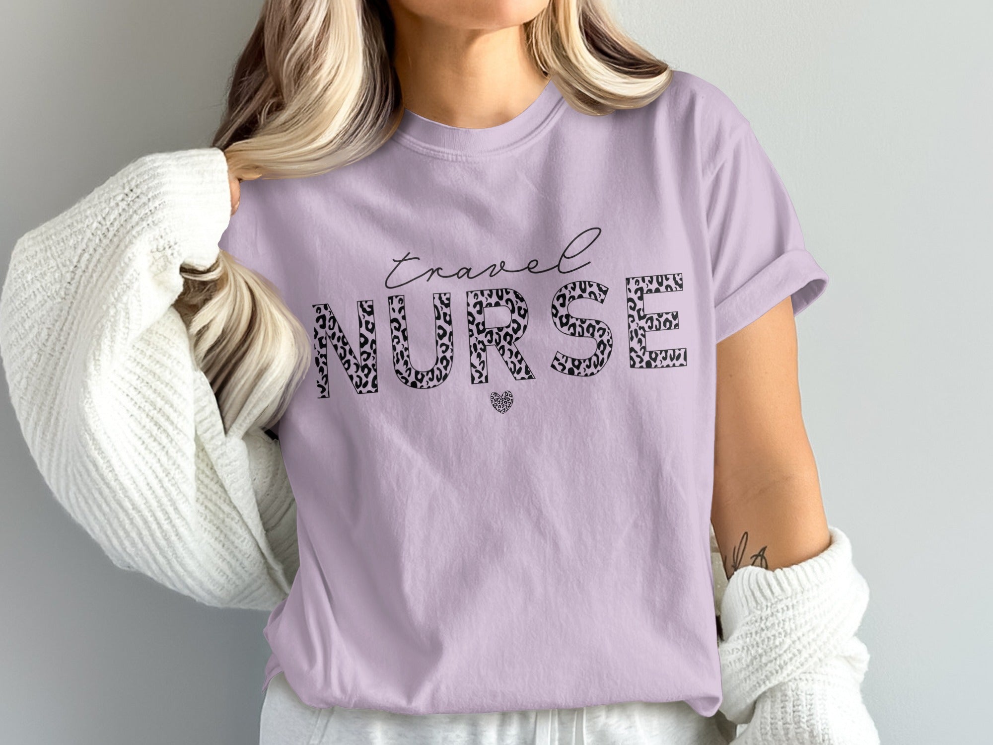 Purple t-shirt with "Travel Nurse" text in leopard print and heart graphic.