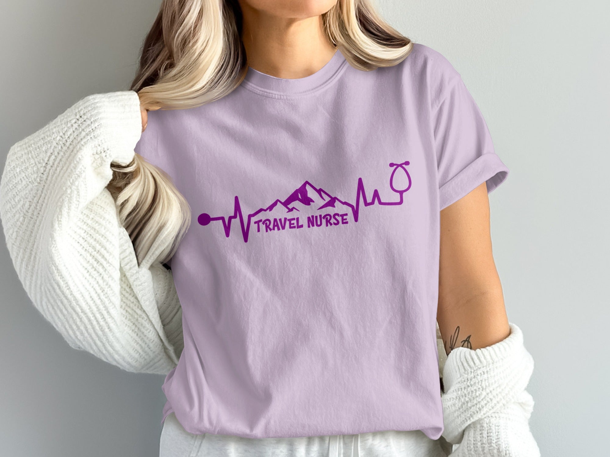 Light purple t-shirt with "TRAVEL NURSE" and mountain/stethoscope heartbeat graphic.