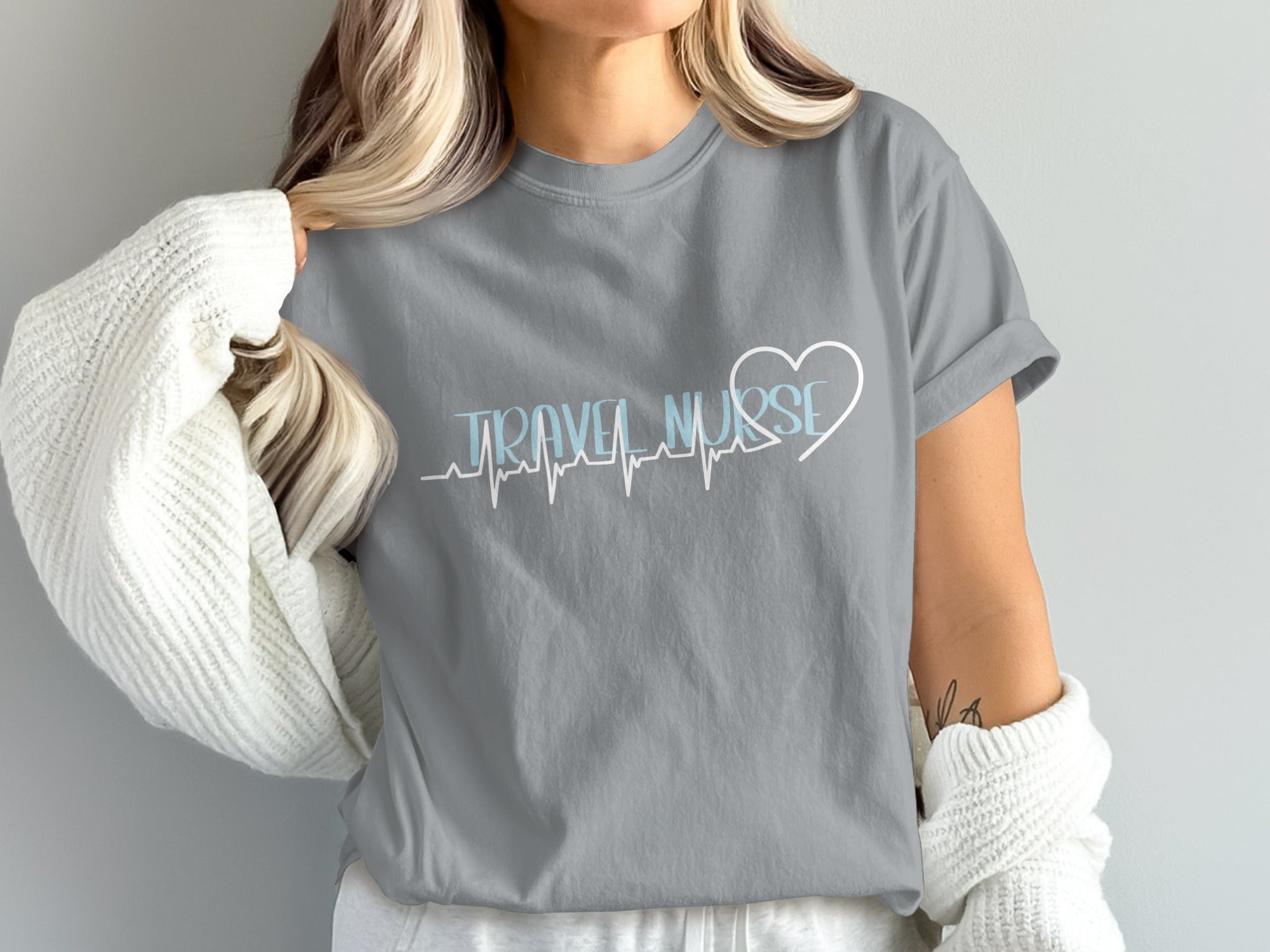 Gray t-shirt with "TRAVEL NURSE" text and a heart-shaped EKG line.