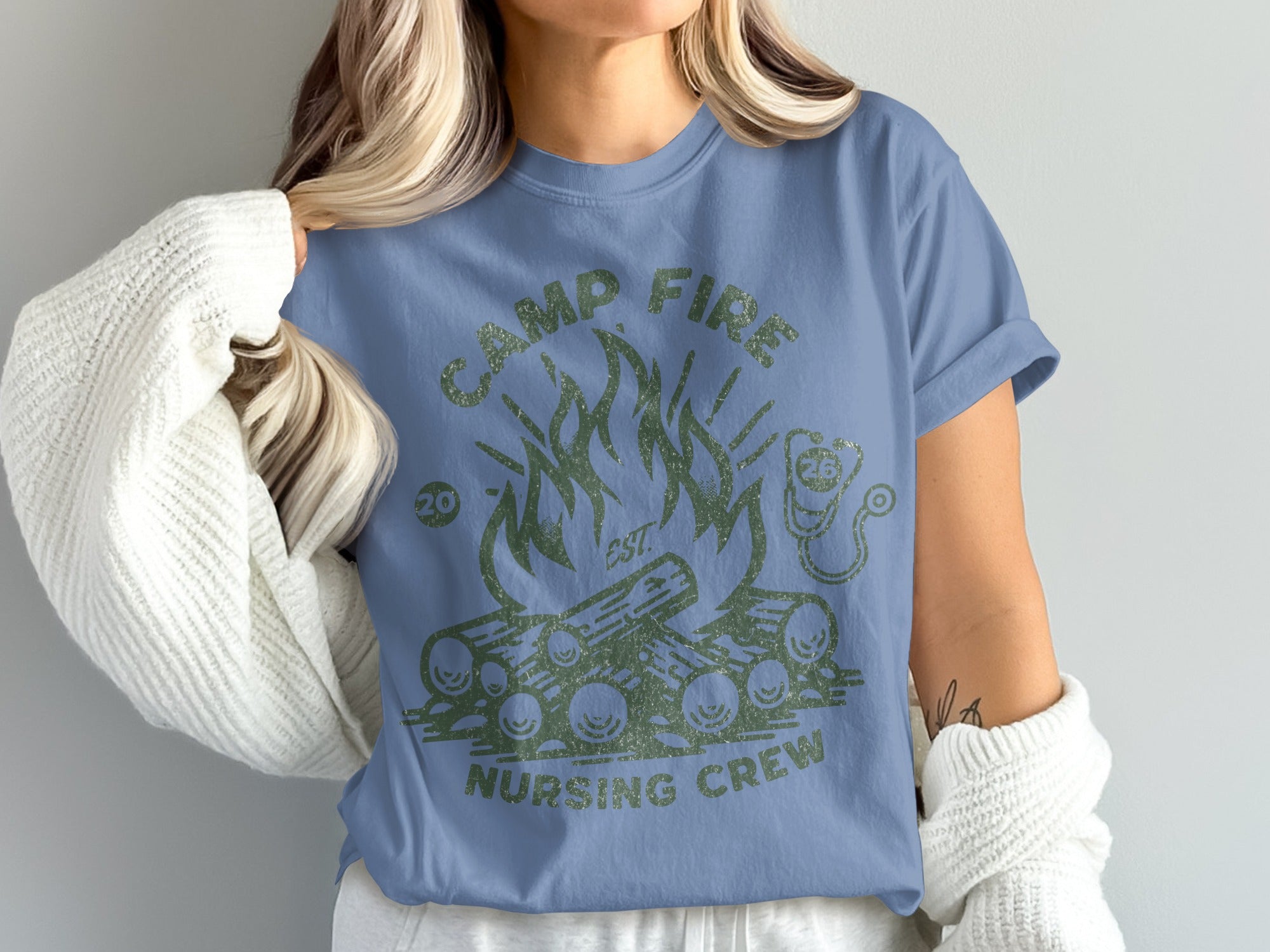 Blue t-shirt with green campfire and "CAMP FIRE NURSING CREW" text.