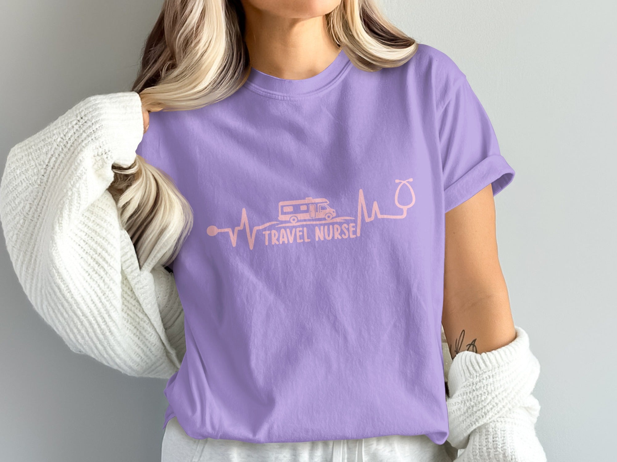 Purple t-shirt with "Travel Nurse" text, RV, and stethoscope electrocardiogram.