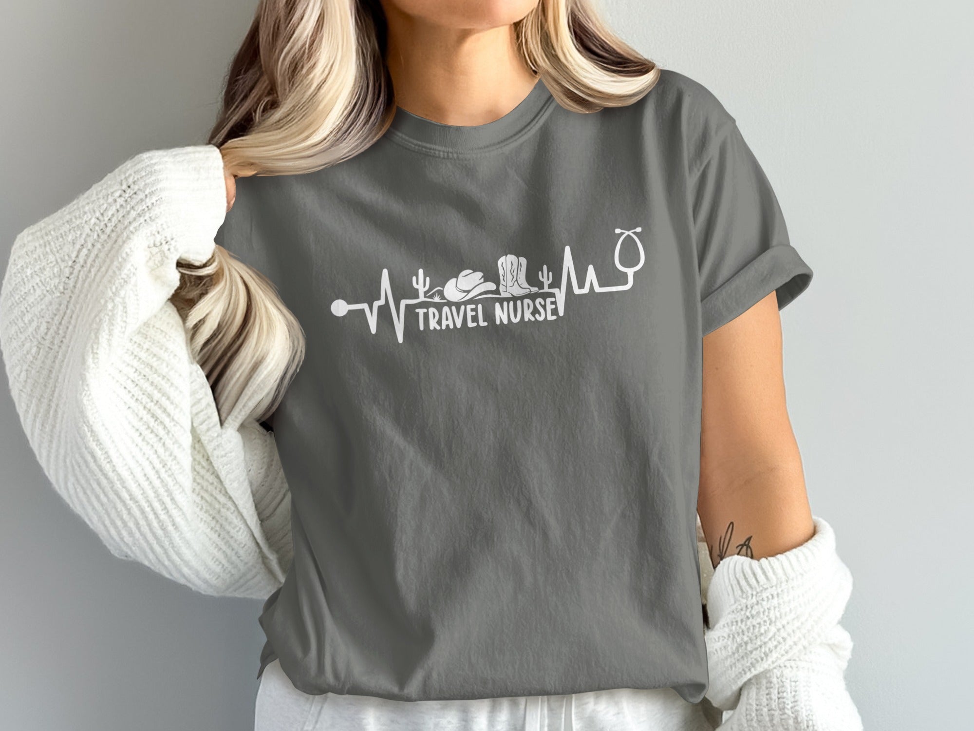 Dark grey t-shirt with white stethoscope and desert travel graphic, "Travel Nurse" text.