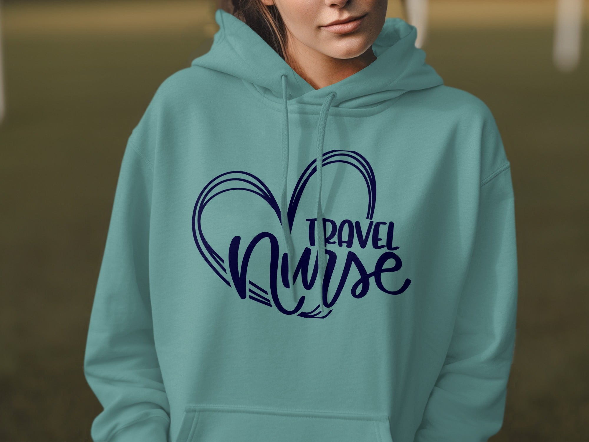 Teal hoodie with "TRAVEL NURSE" text inside a heart outline.