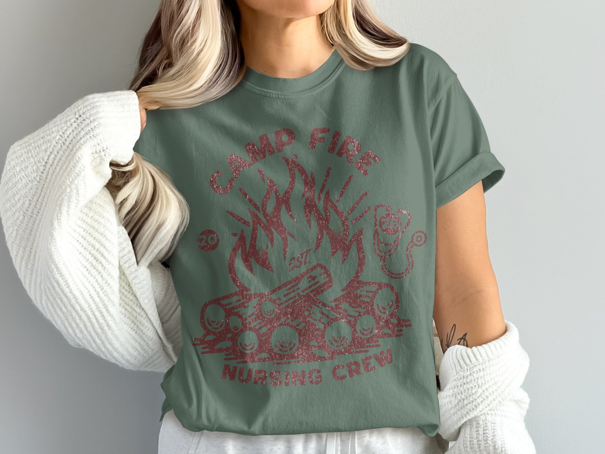Green t-shirt with "Camp Fire Nursing Crew" text and campfire graphic.