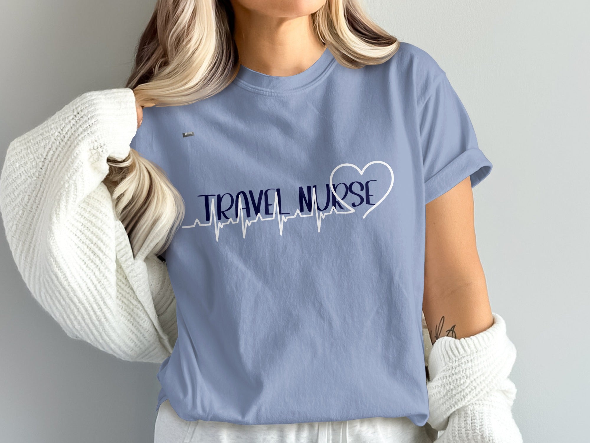 Light blue t-shirt with "TRAVEL NURSE" text and heart heartbeat design.