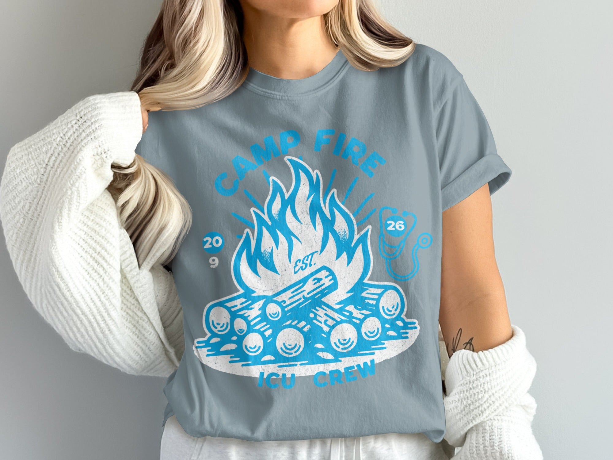 Blue t-shirt with campfire graphic and text "Camp Fire ICU Crew 2029 26".