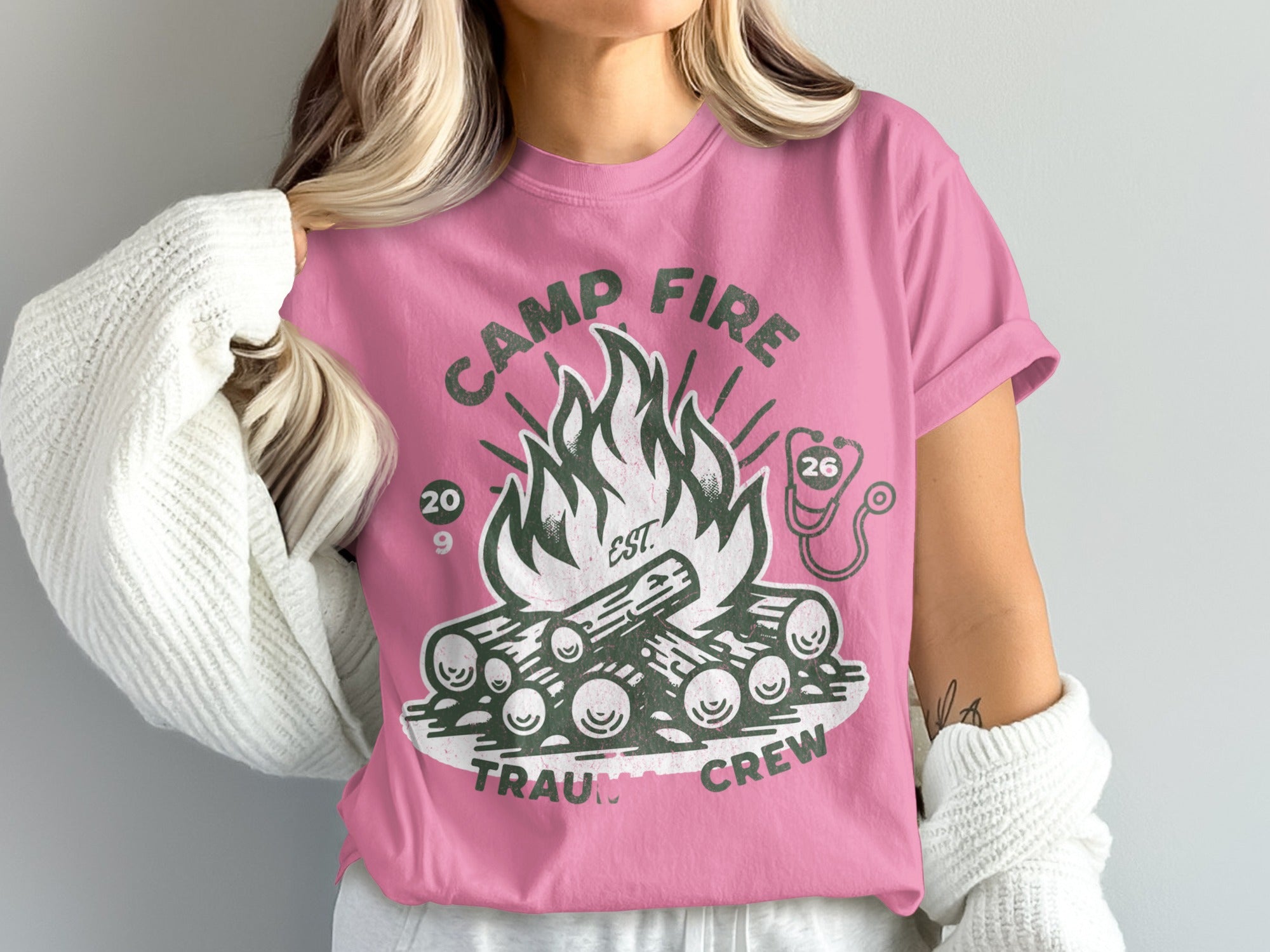 Pink t-shirt with campfire and "Camp Fire Trauma Crew" text.