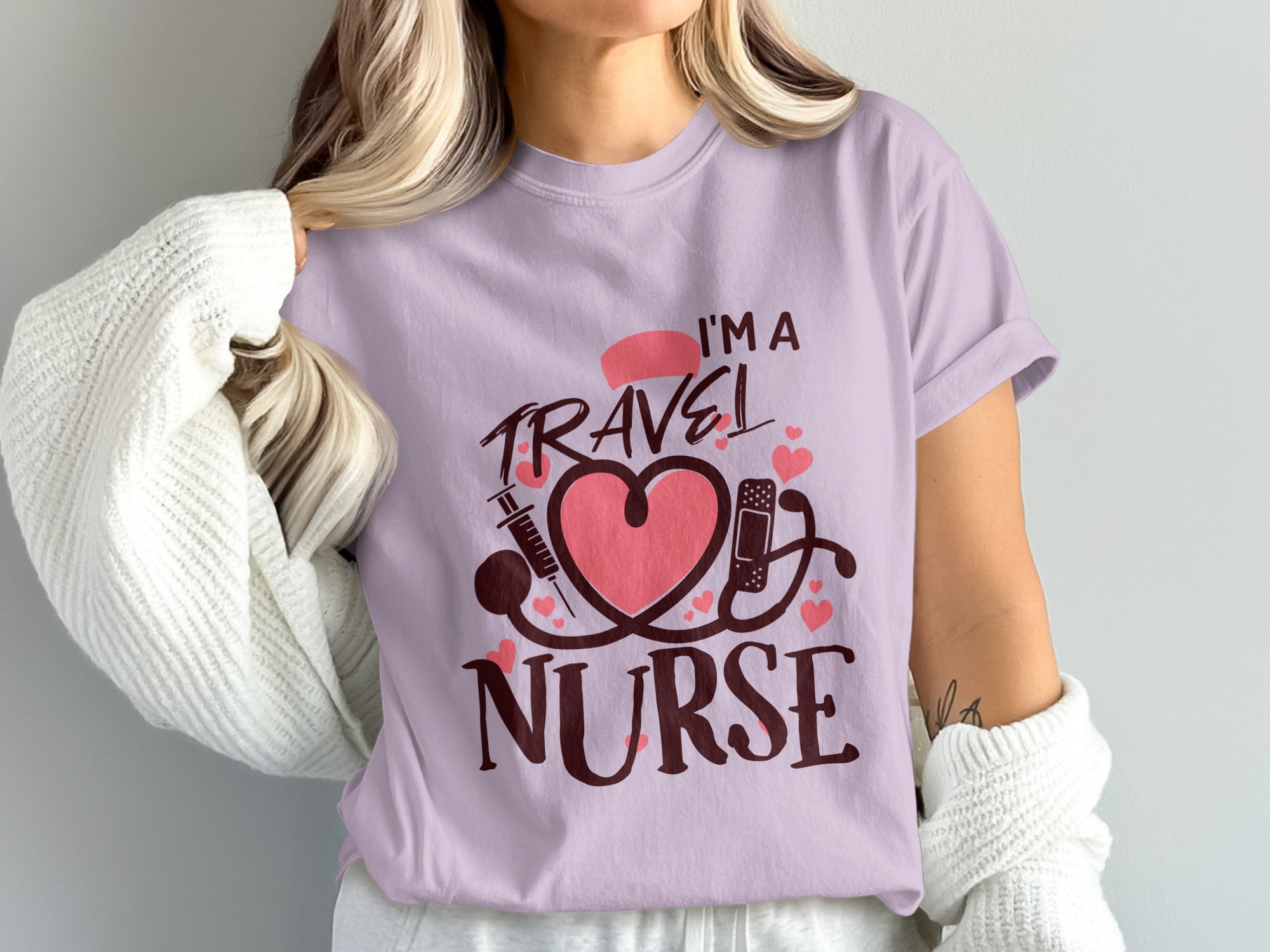 Lilac t-shirt with "I'm a Travel Nurse" text and medical symbols.