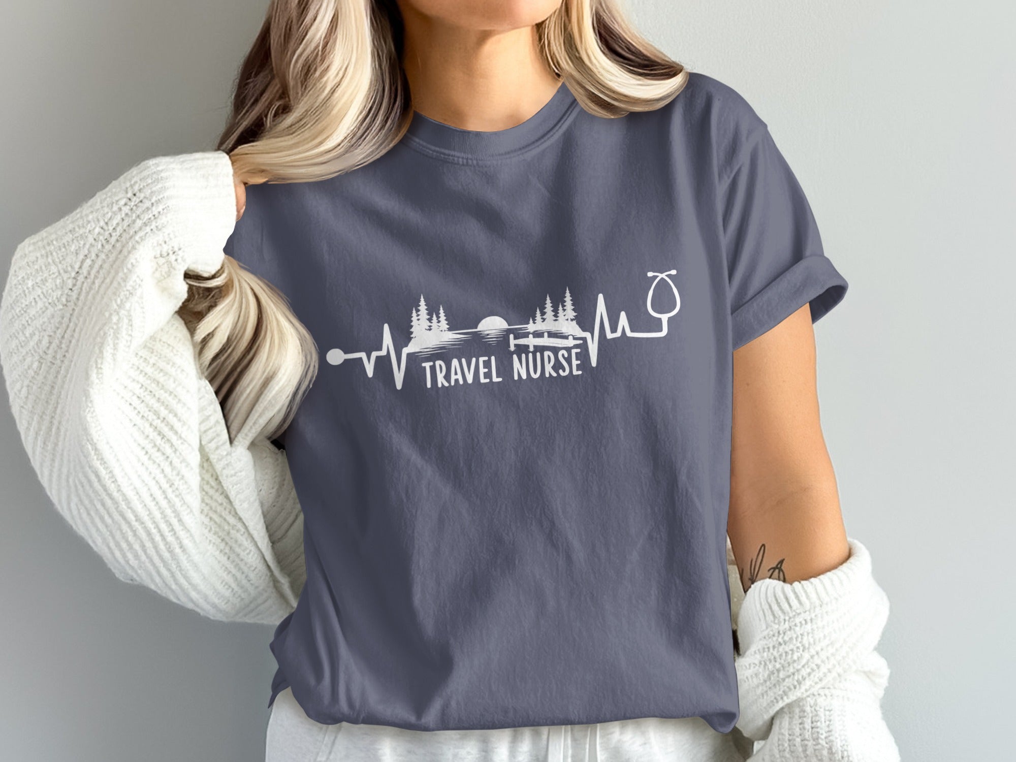 Dark blue t-shirt with a white heartbeat graphic and "TRAVEL NURSE" text.