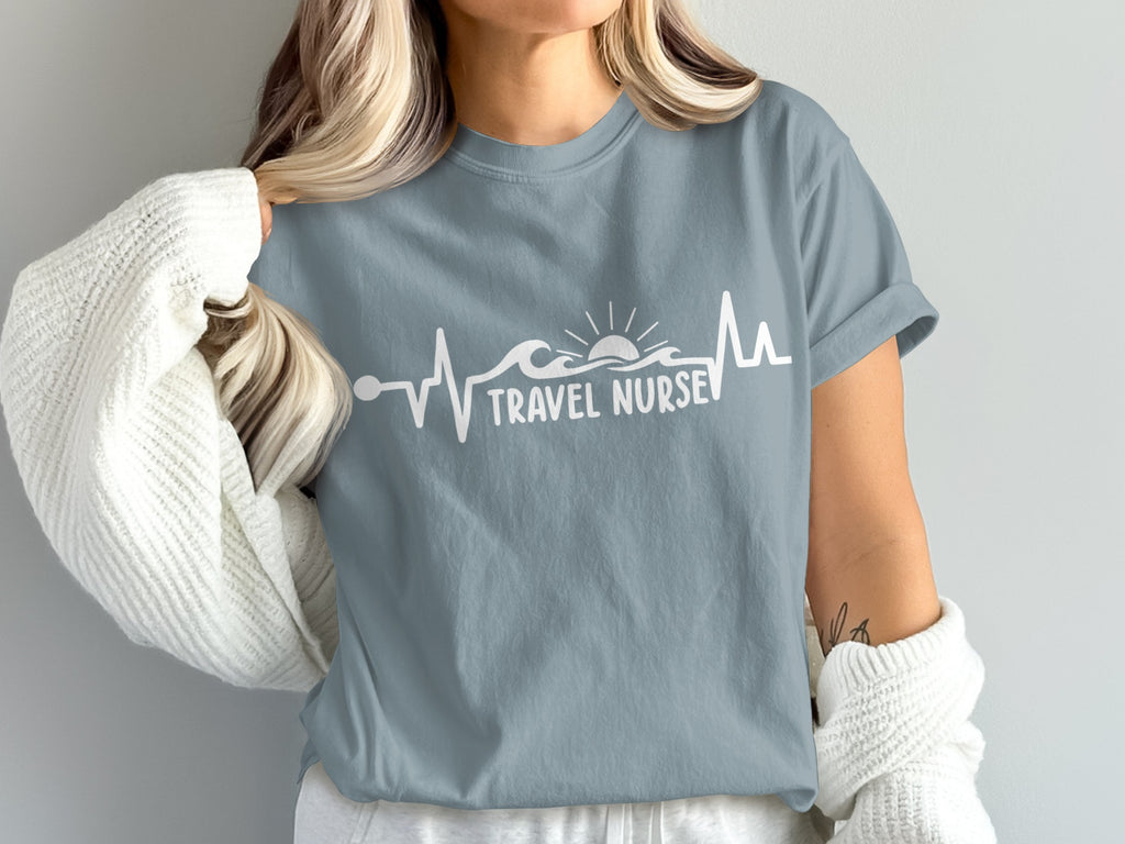 Gray t-shirt with "TRAVEL NURSE" text and a heartbeat line with waves and a sun.