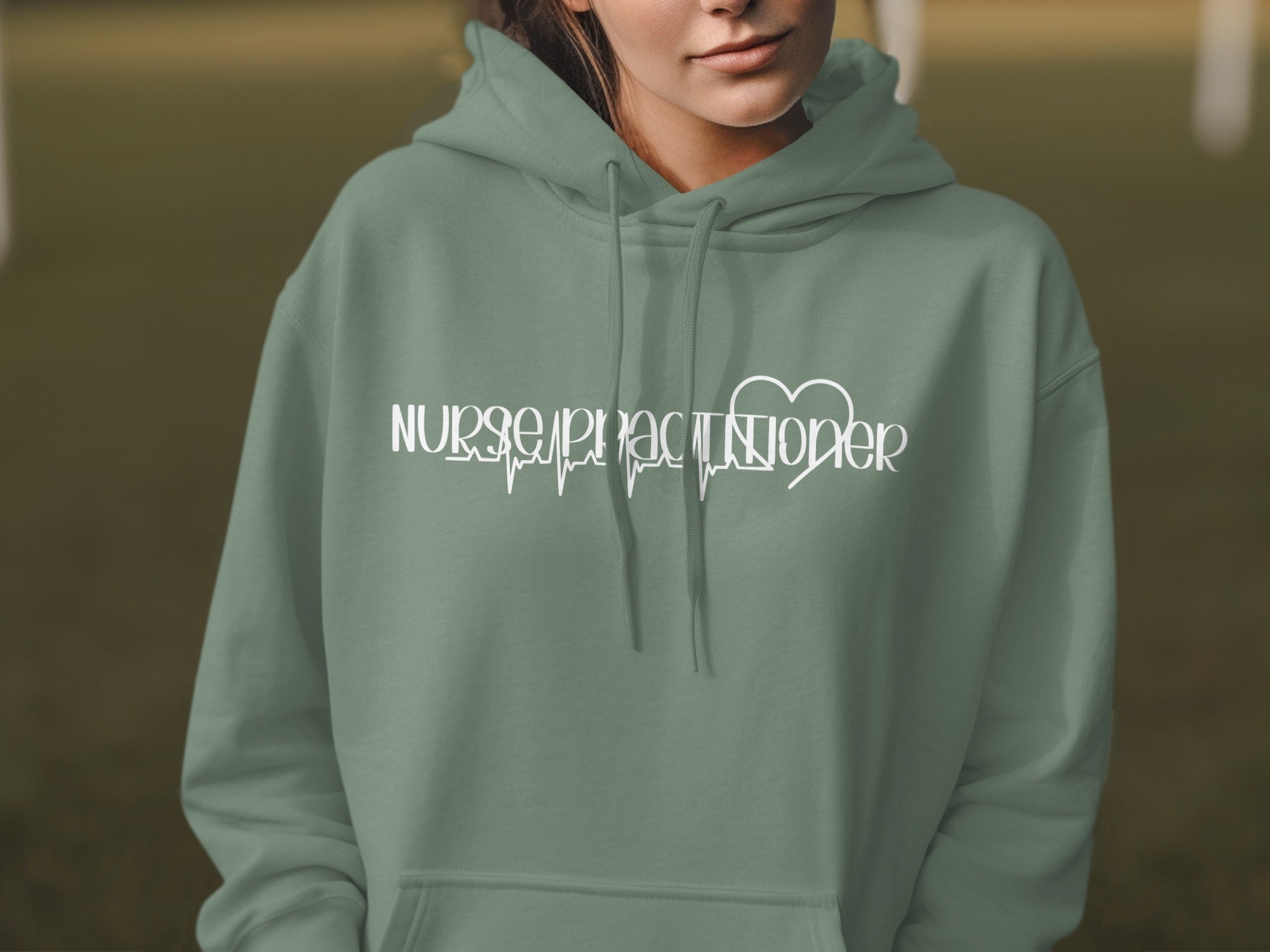 Sage green hoodie with "Nurse Practitioner" text and heartbeat graphic.