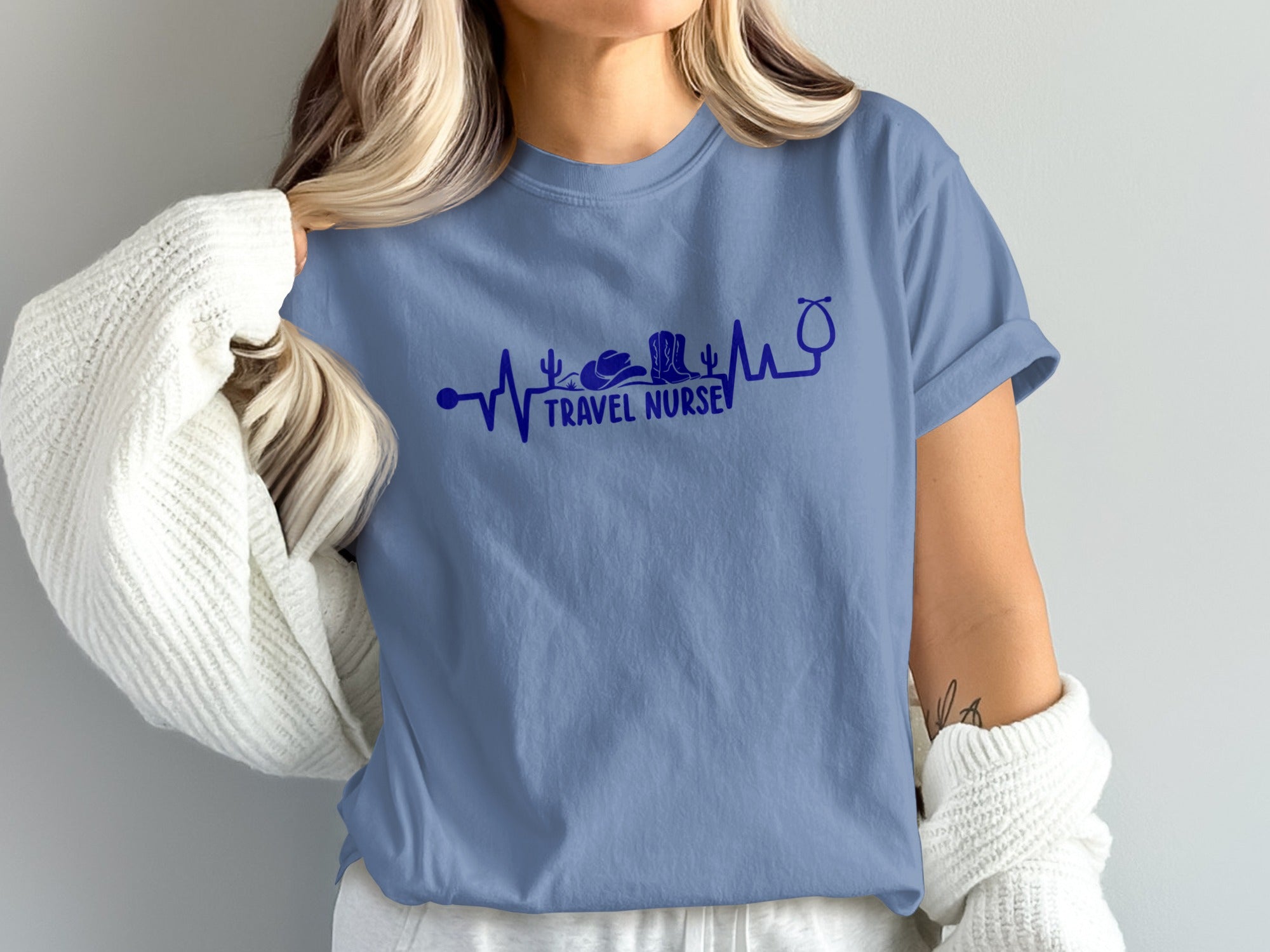 Blue t-shirt with a stethoscope forming a heartbeat line and "Travel Nurse" text.
