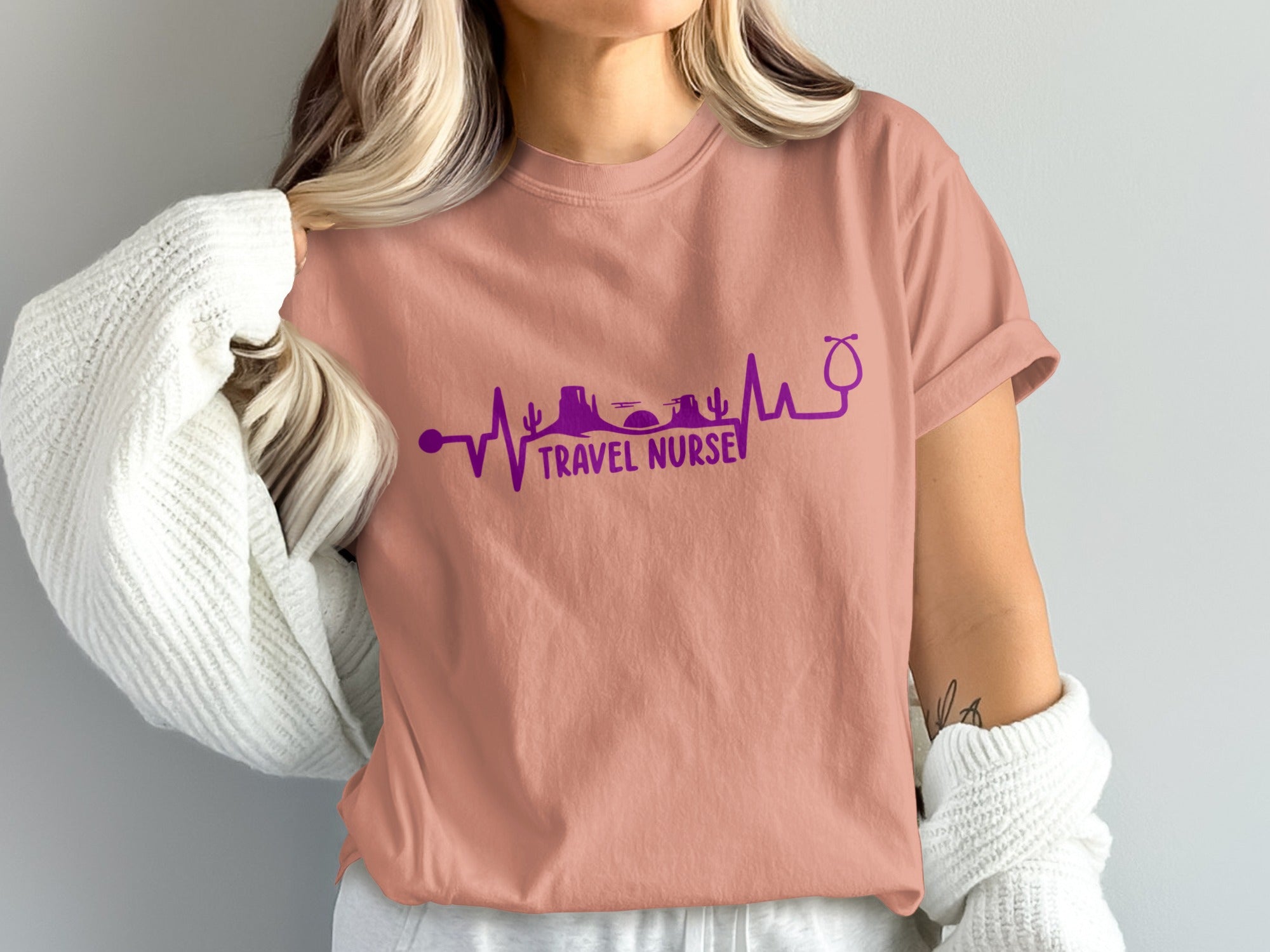 T-shirt with purple "Travel Nurse" heartbeat graphic and stethoscope.