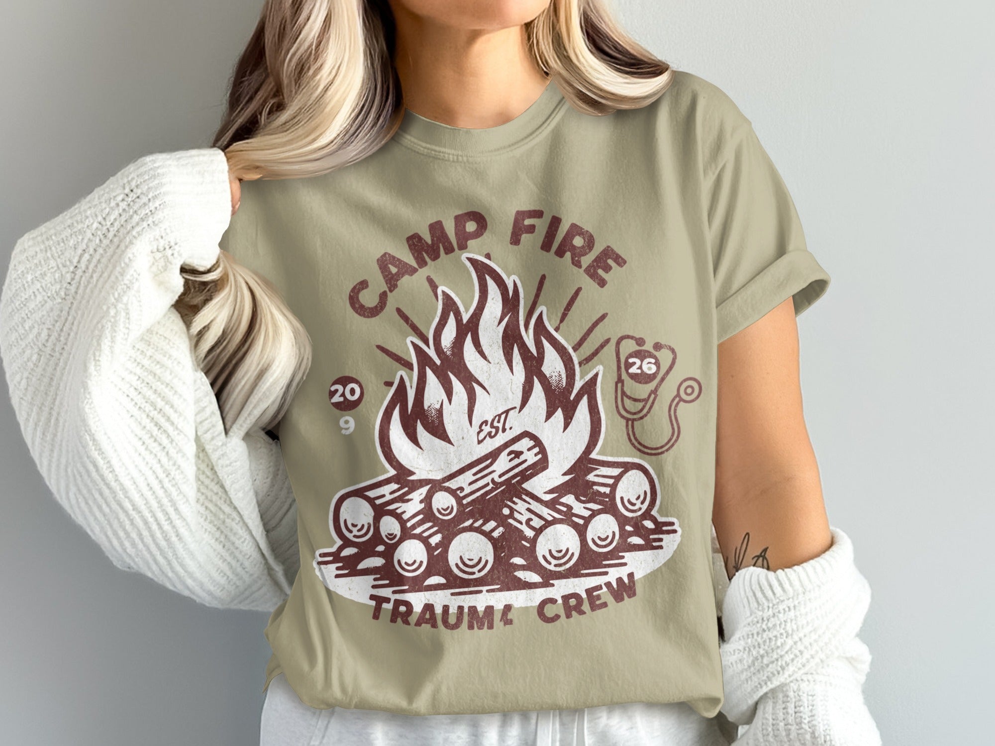 Camp Fire Trauma Crew graphic with campfire, logs, and stethoscope.