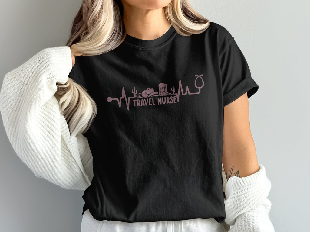 Black t-shirt with a pink heartbeat line featuring a stethoscope, cowboy hat, and boots.