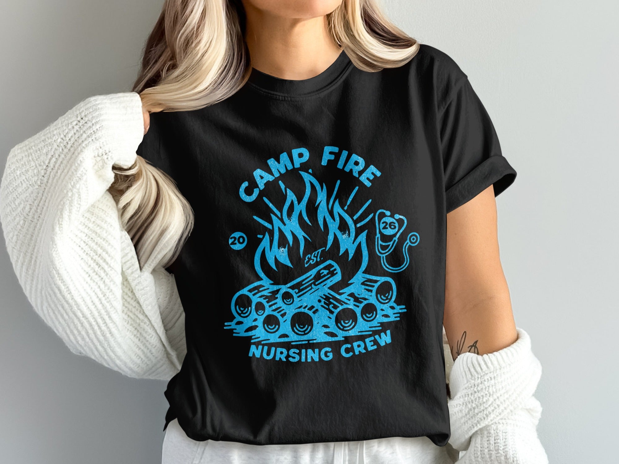 Black t-shirt with a campfire graphic and "Camp Fire Nursing Crew" text.