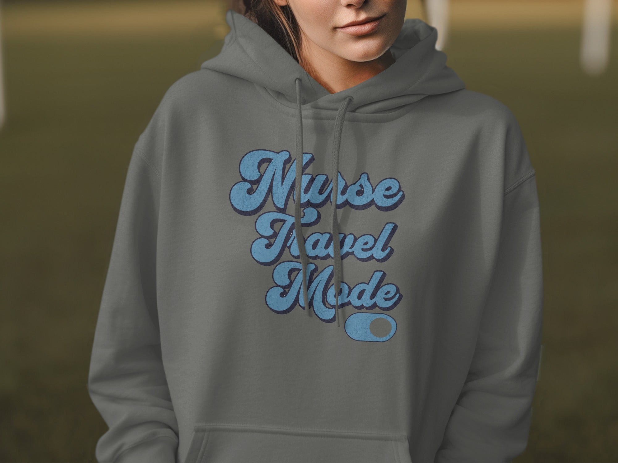 Gray hoodie with "Nurse Travel Mode" text in blue retro font.