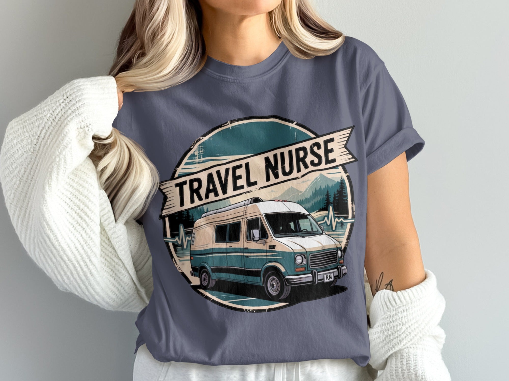 RV and mountains graphic on a dark blue t-shirt.