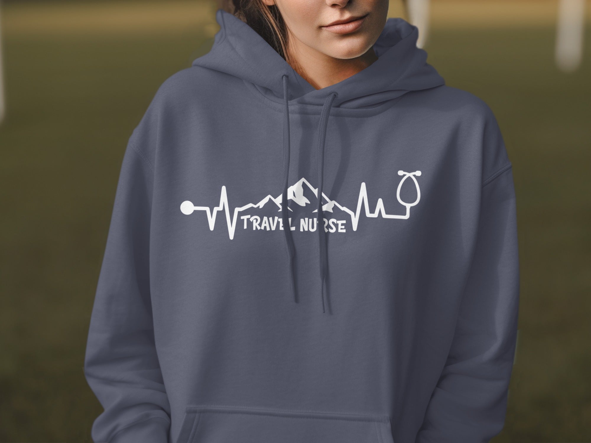 Dark grey hoodie with "TRAVEL NURSE" and heartbeat/mountain graphic.