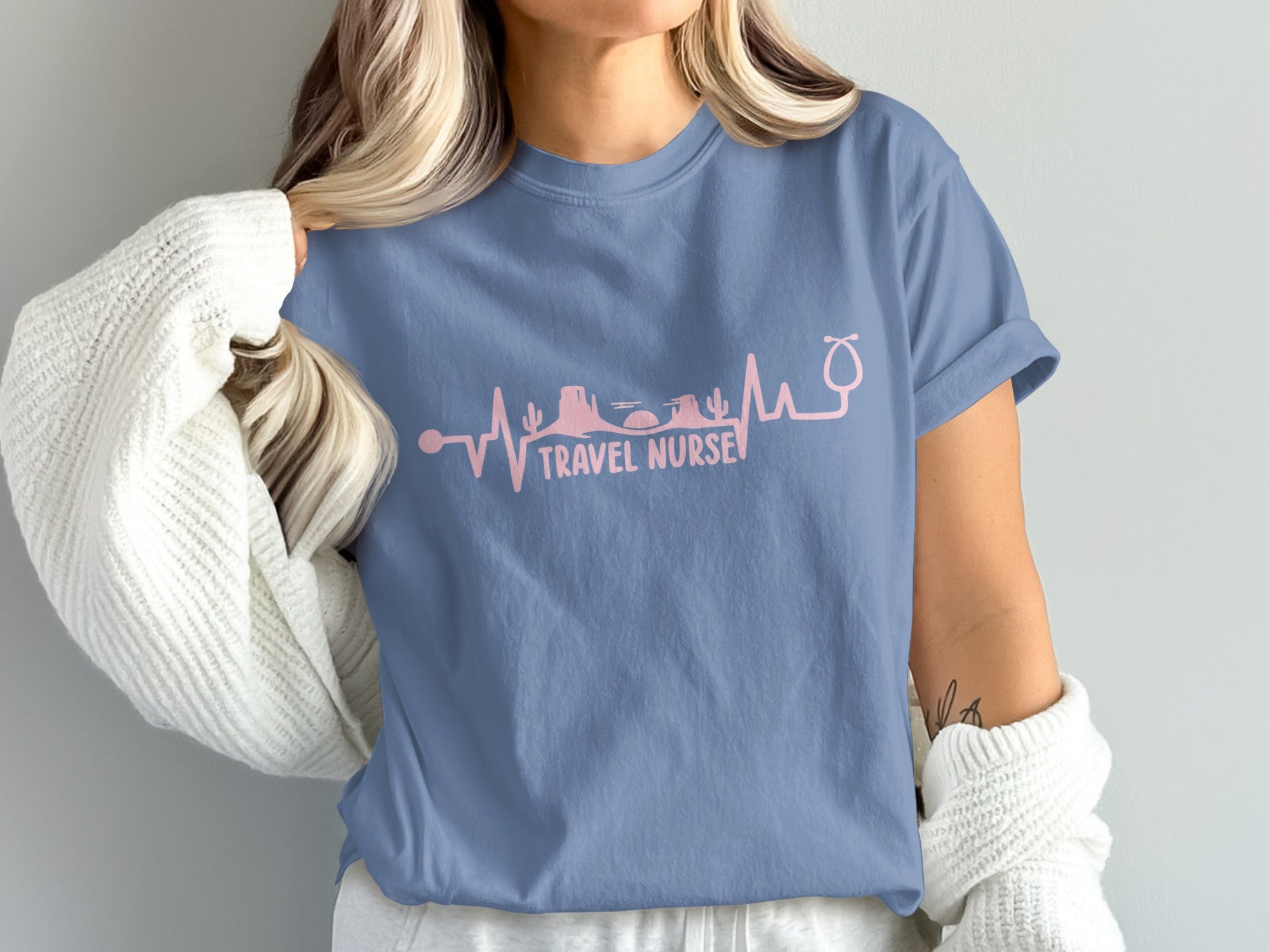 Blue t-shirt with pink stethoscope and desert landscape heartbeat graphic.
