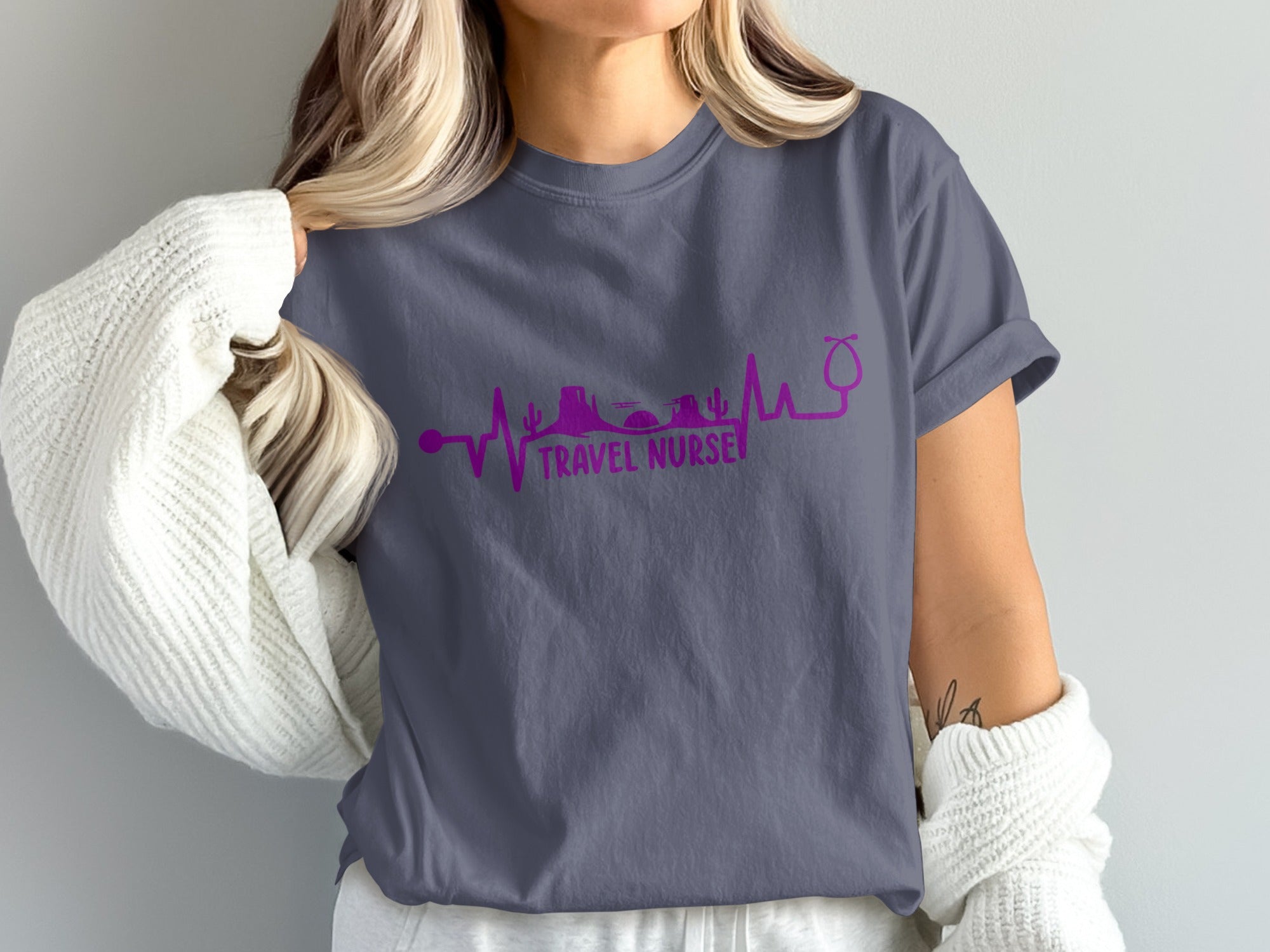 Purple heartbeat line graphic with desert landscape and stethoscope on t-shirt.