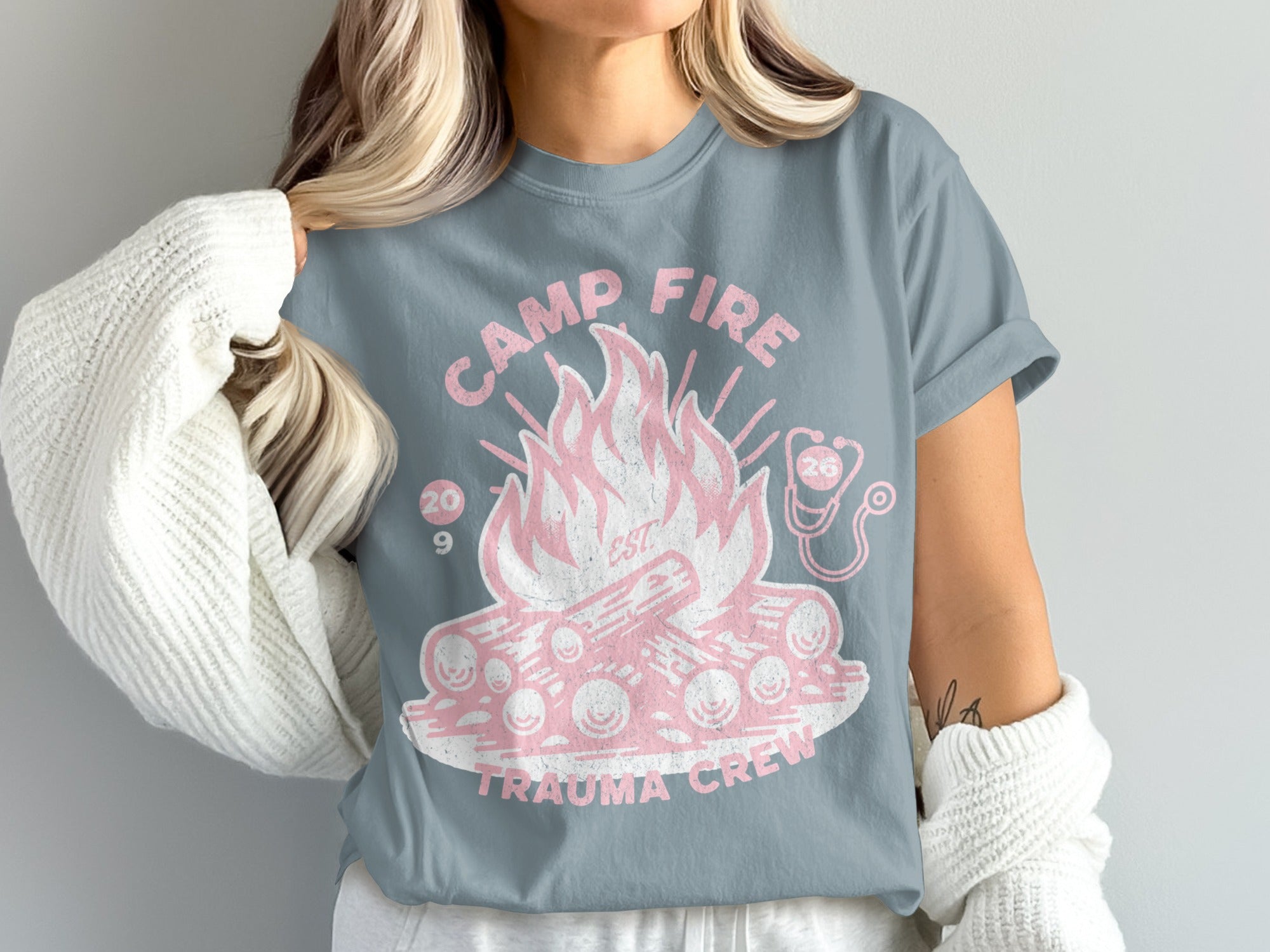 Camp Fire Trauma Crew graphic t-shirt with pink campfire and stethoscope.