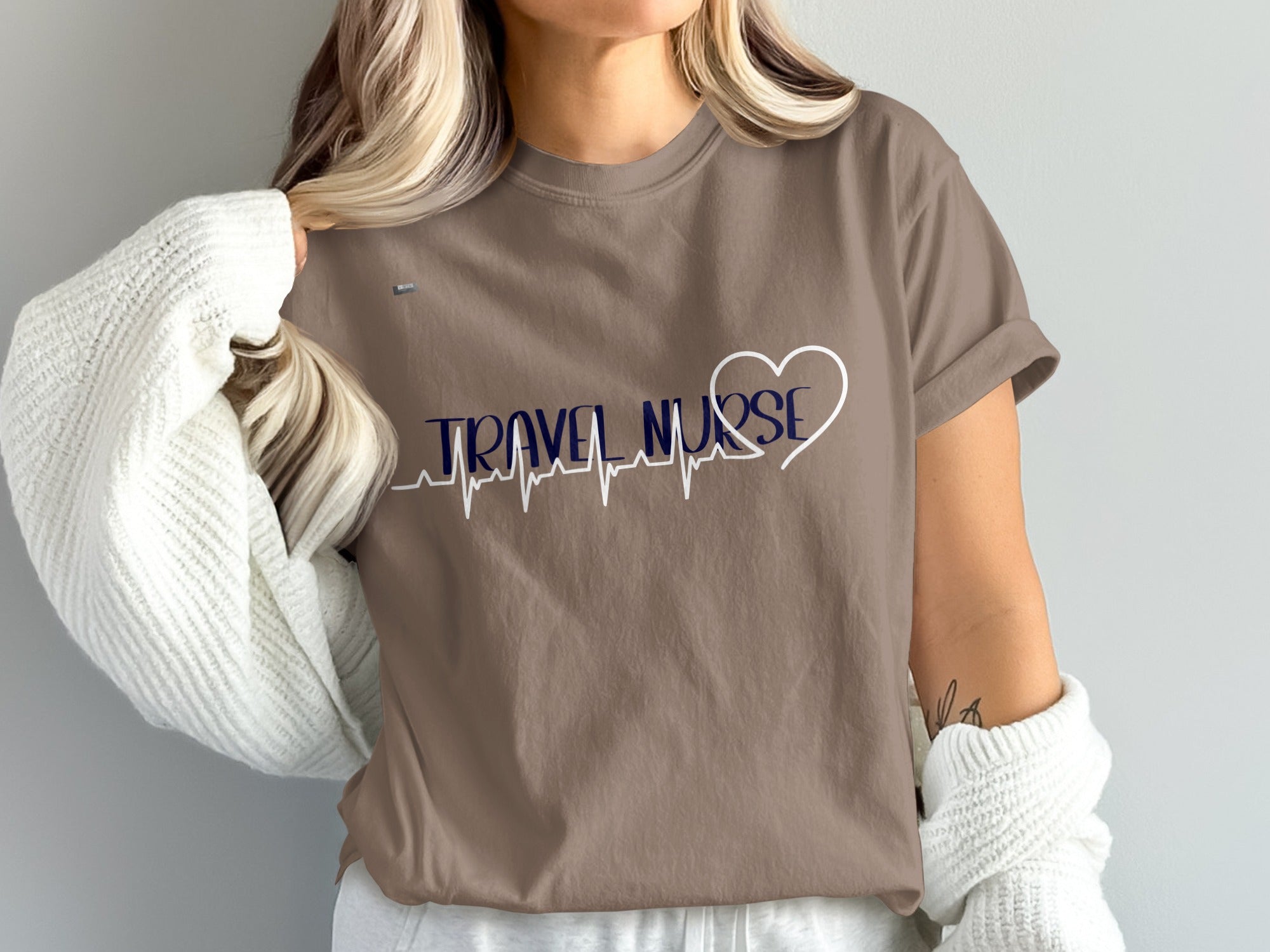 Brown t-shirt with navy blue "TRAVEL NURSE" text and a heart ECG line.