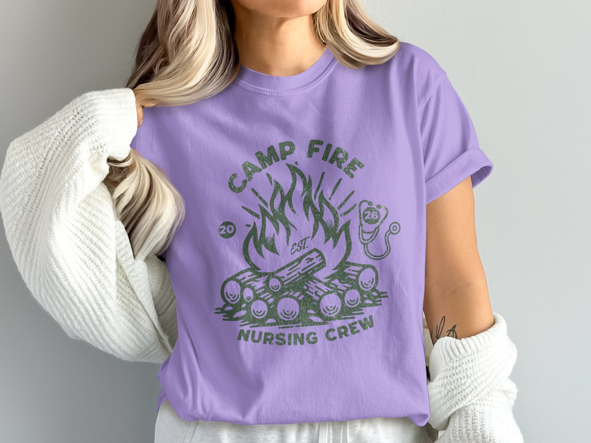 Camp Fire Nursing Crew graphic on a light purple t-shirt.